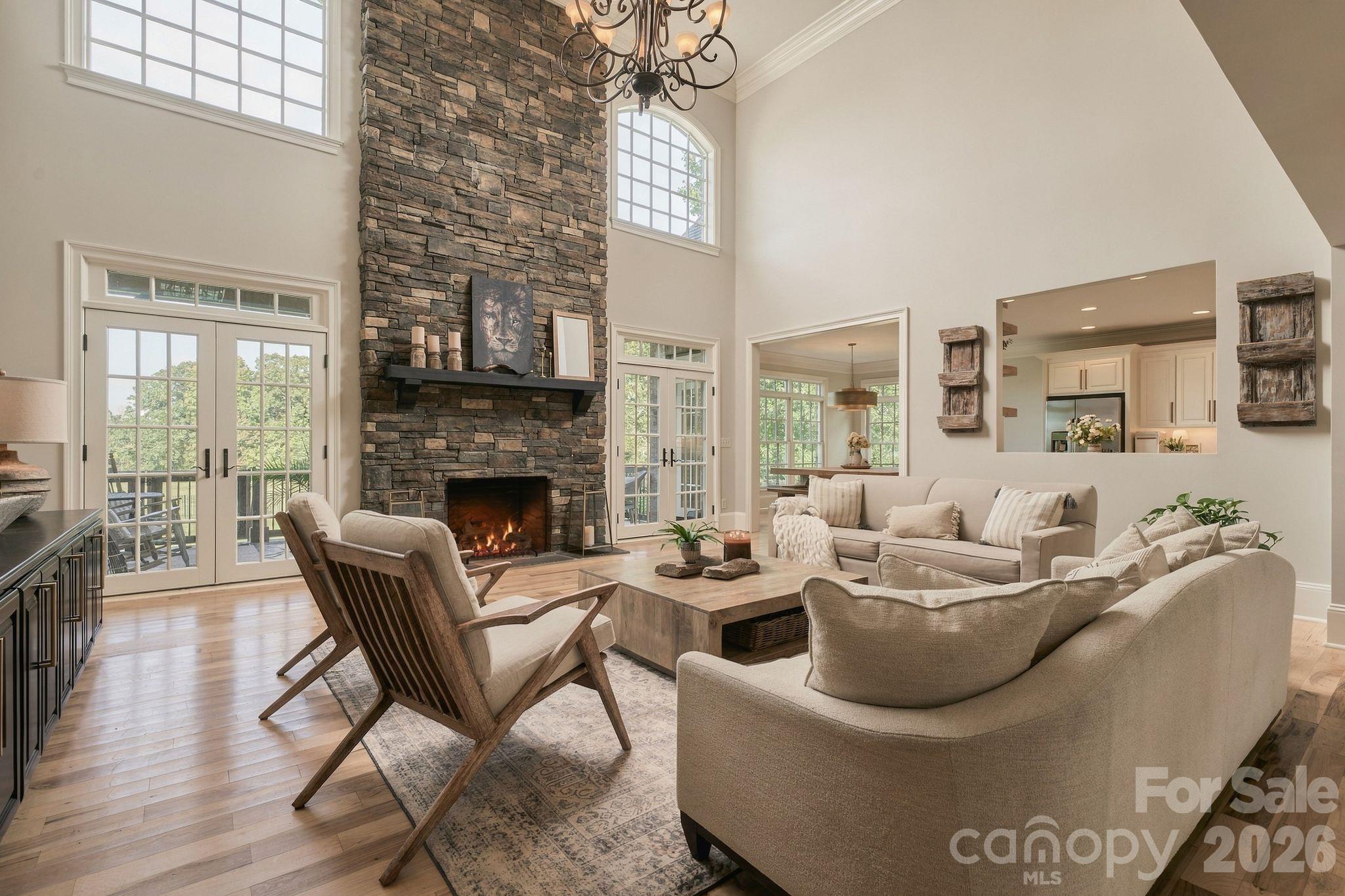 Grand two-story great room anchored by stone floor to ceiling gas fireplace - 7275 Flowes Store Road, Concord