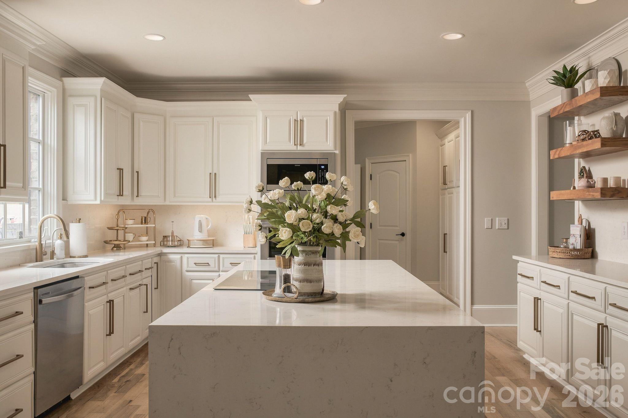 Large waterfall island with electric cooktop and stainless steel appliances - 7275 Flowes Store Road, Concord