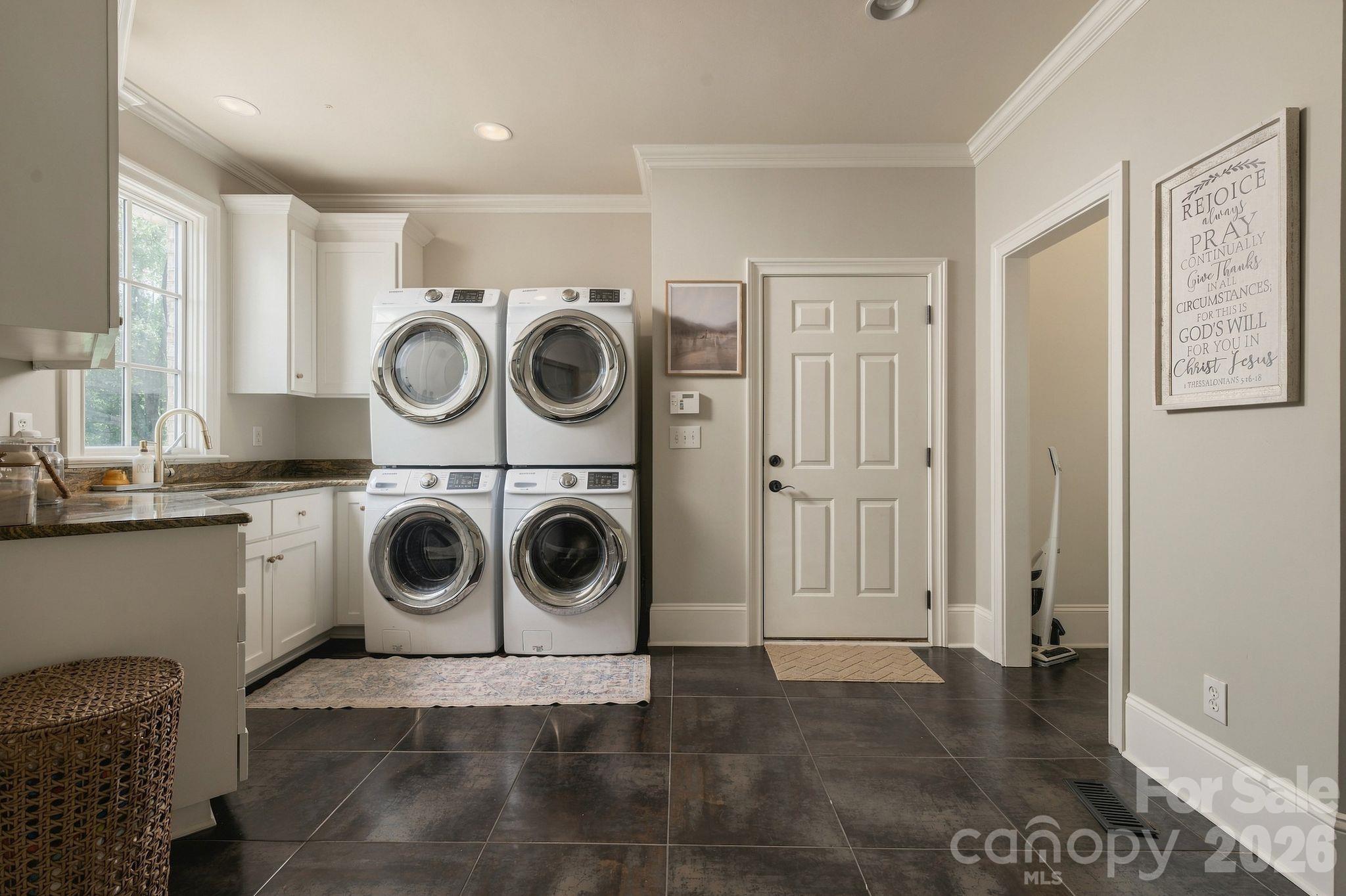 Large laundry room with full counter top, sink, and storage - 7275 Flowes Store Road, Concord