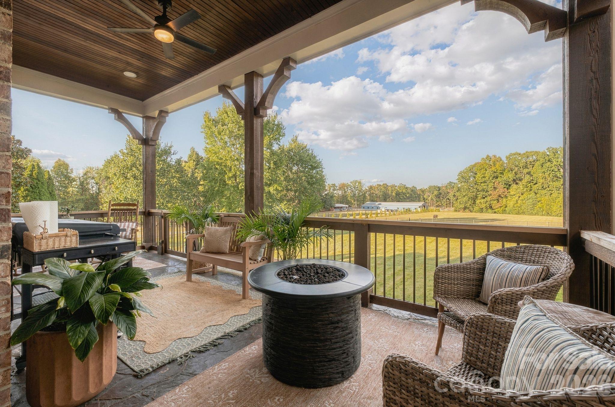 Relax and unwind on the main level covered patio with gorgeous wooded views - 7275 Flowes Store Road, Concord