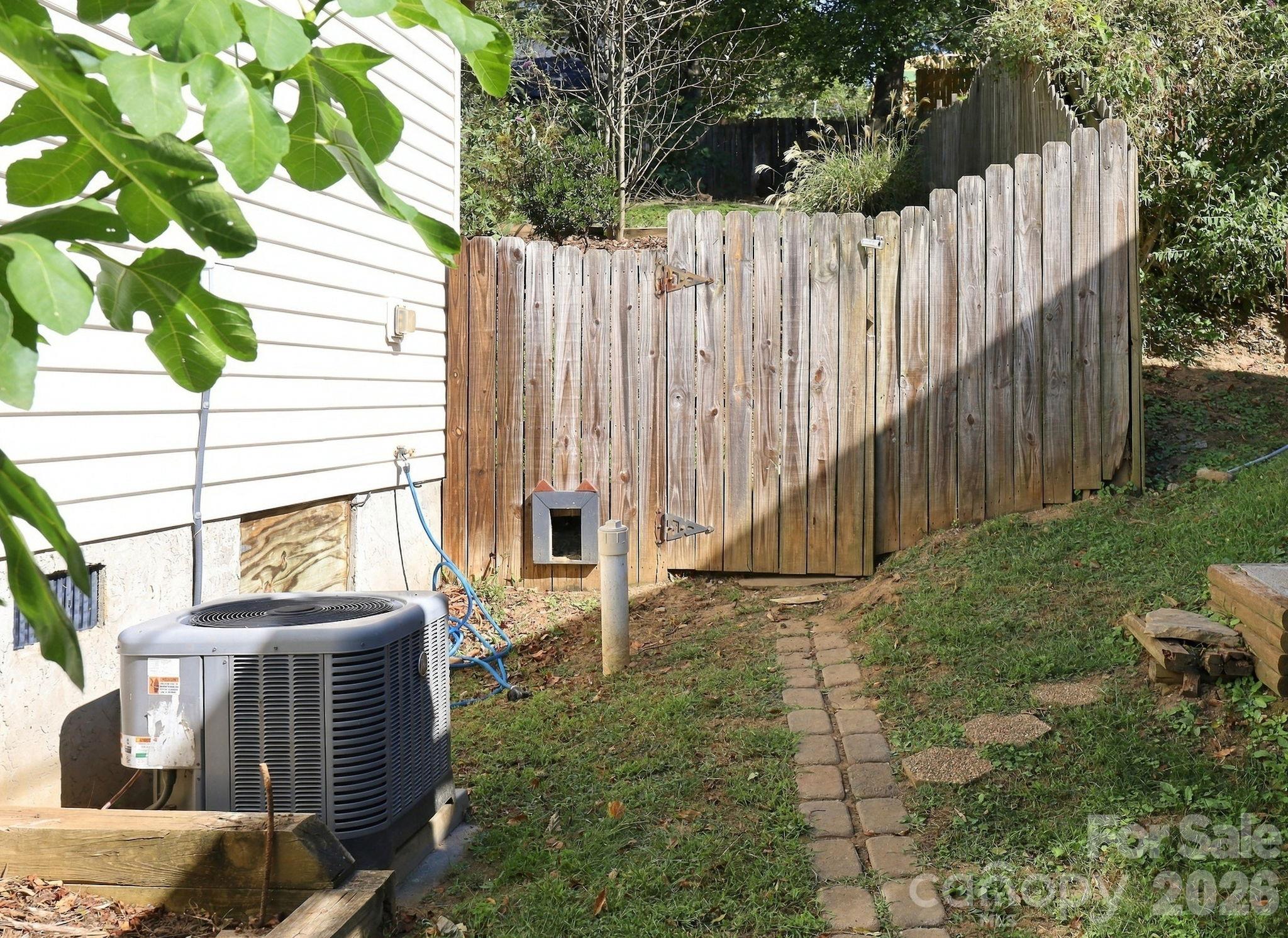 Side of house, gated fenced in yard - 10 Foggy Hollow Trail, Asheville