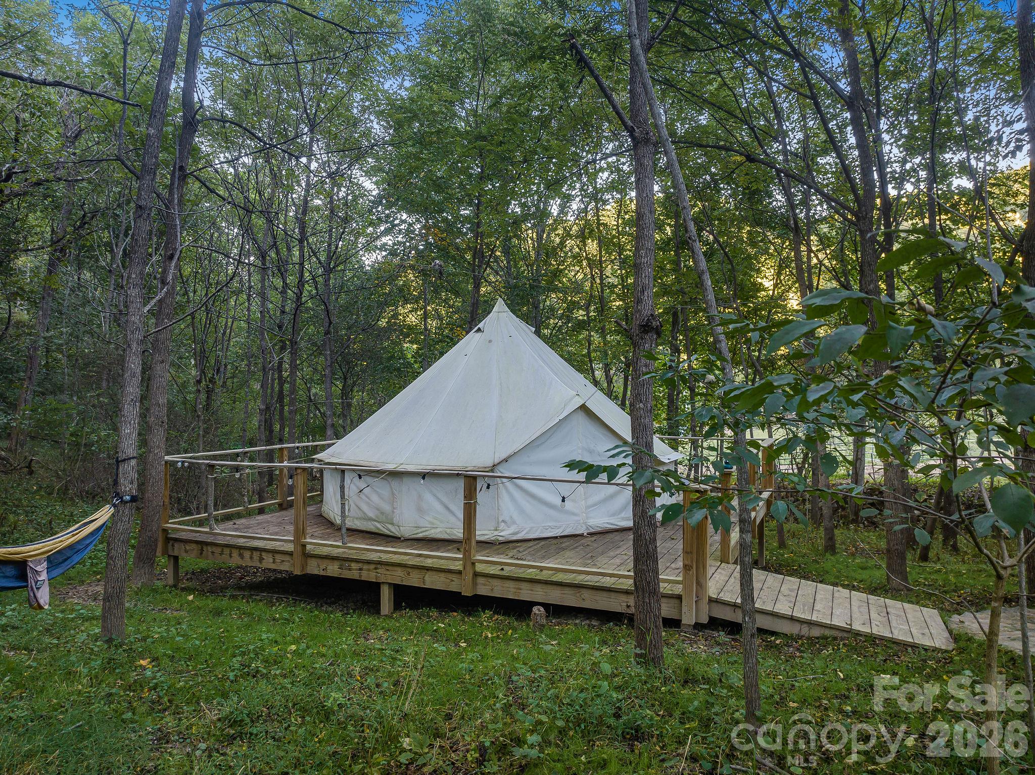 The sellers added this delightful glamping site that's one of the most peaceful corners of the property with a creek running by. - 1102 Price Town Road, Clyde