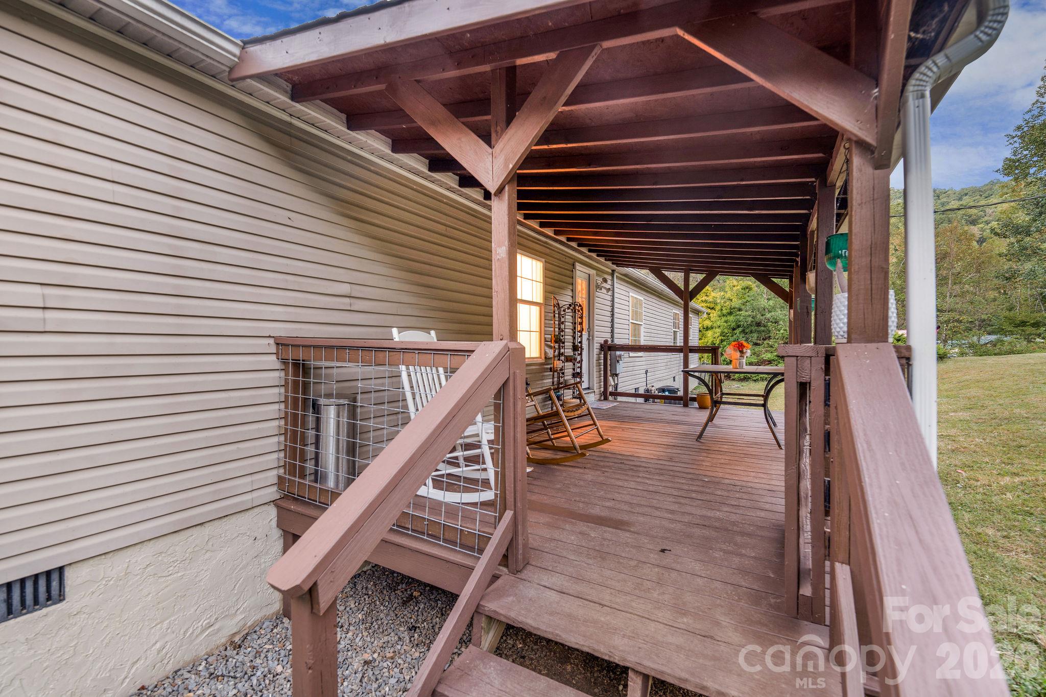 Back covered deck with stairs on both sides. - 1102 Price Town Road, Clyde