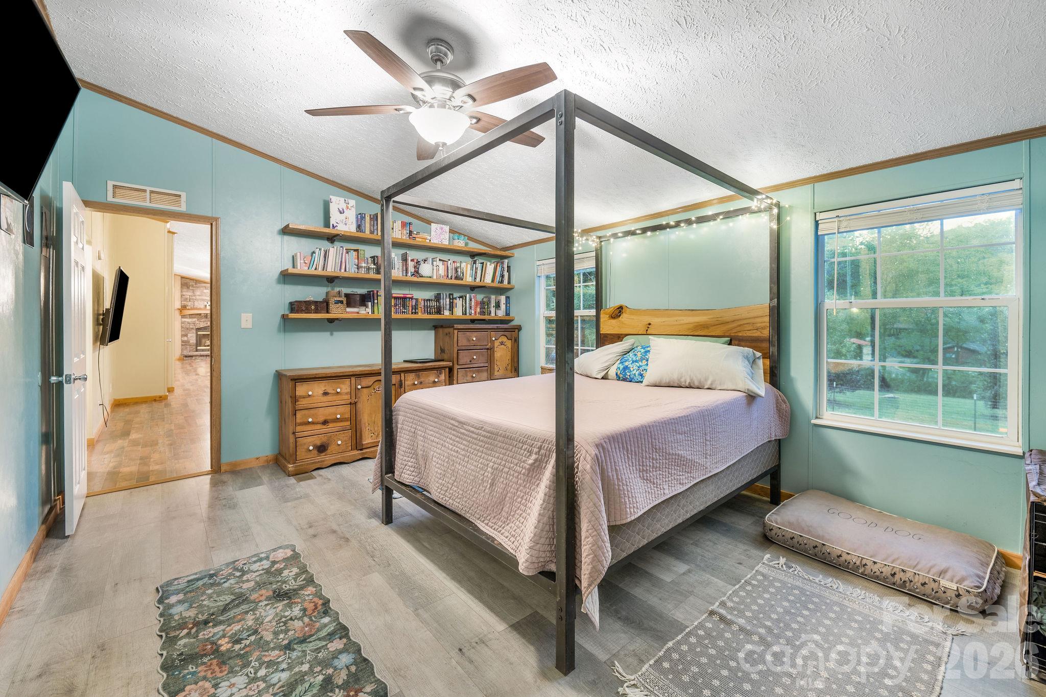 Primary bedroom with gorgeous wood shelves and walk-in closet. - 1102 Price Town Road, Clyde