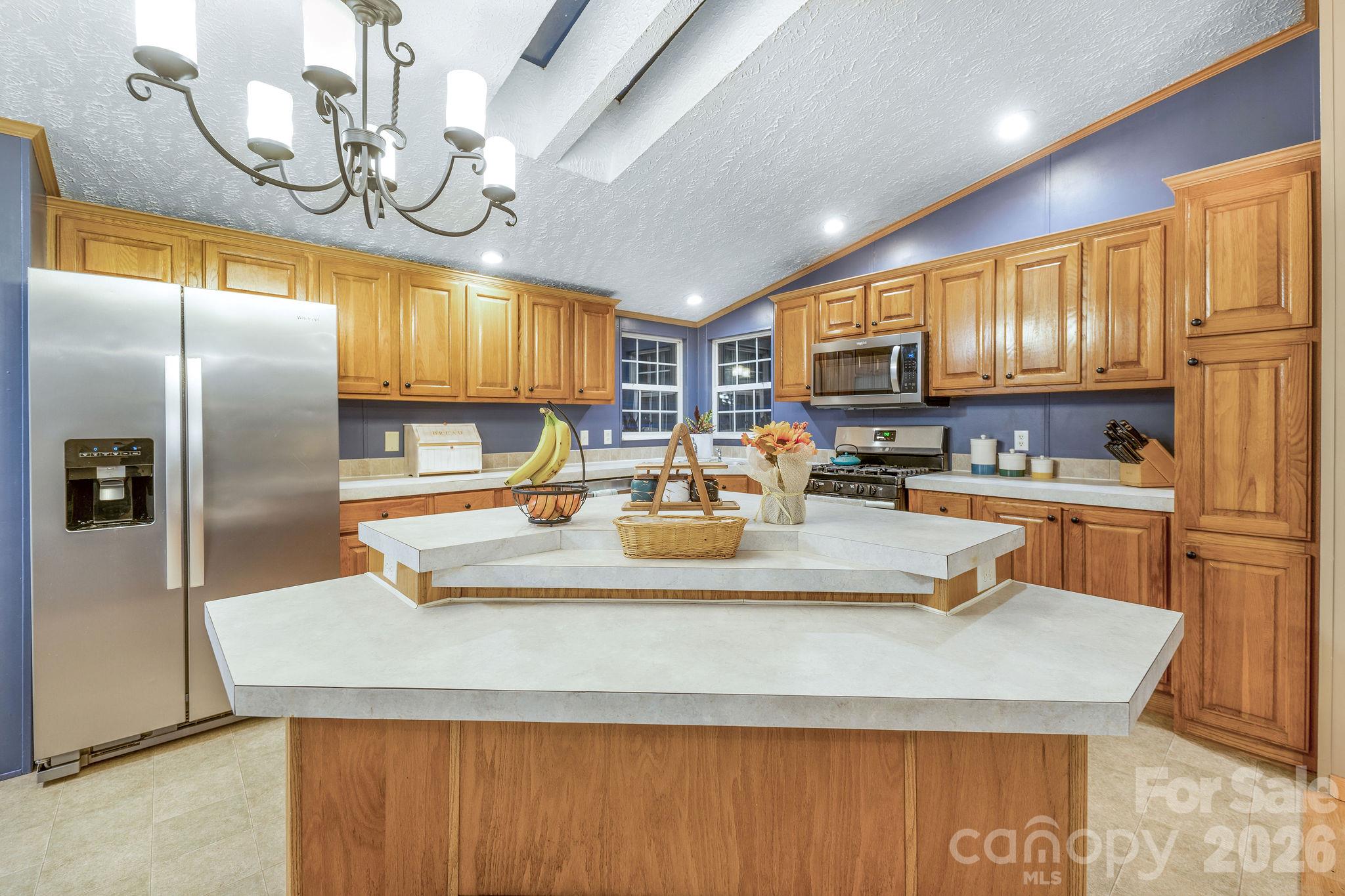 Large tiered kitchen island with breakfast bar. - 1102 Price Town Road, Clyde