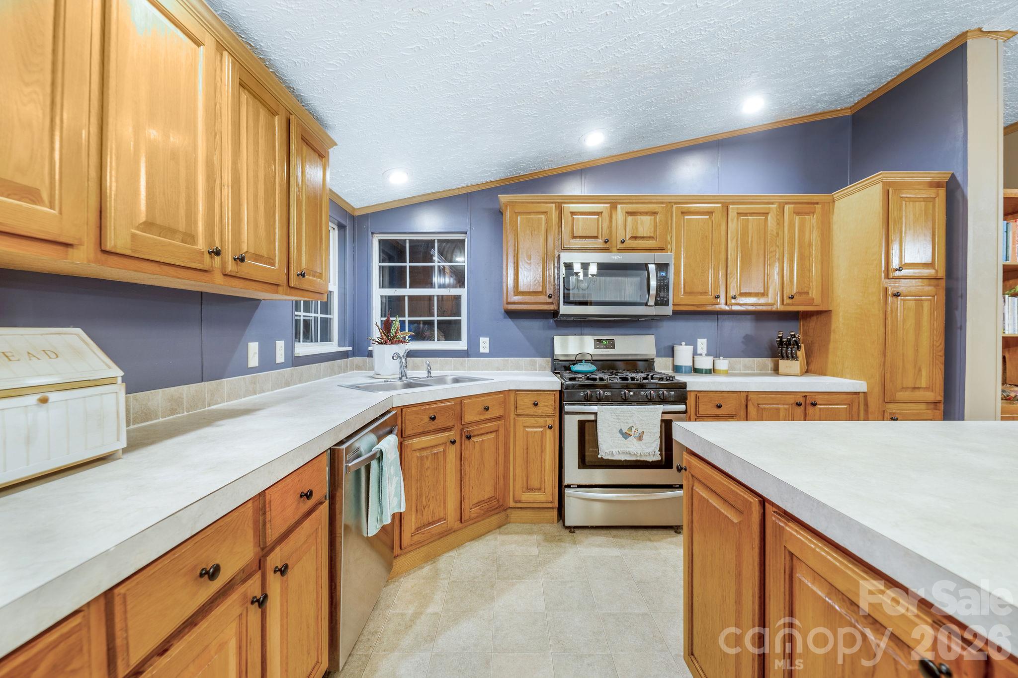 View of kitchen from one side of the island. - 1102 Price Town Road, Clyde