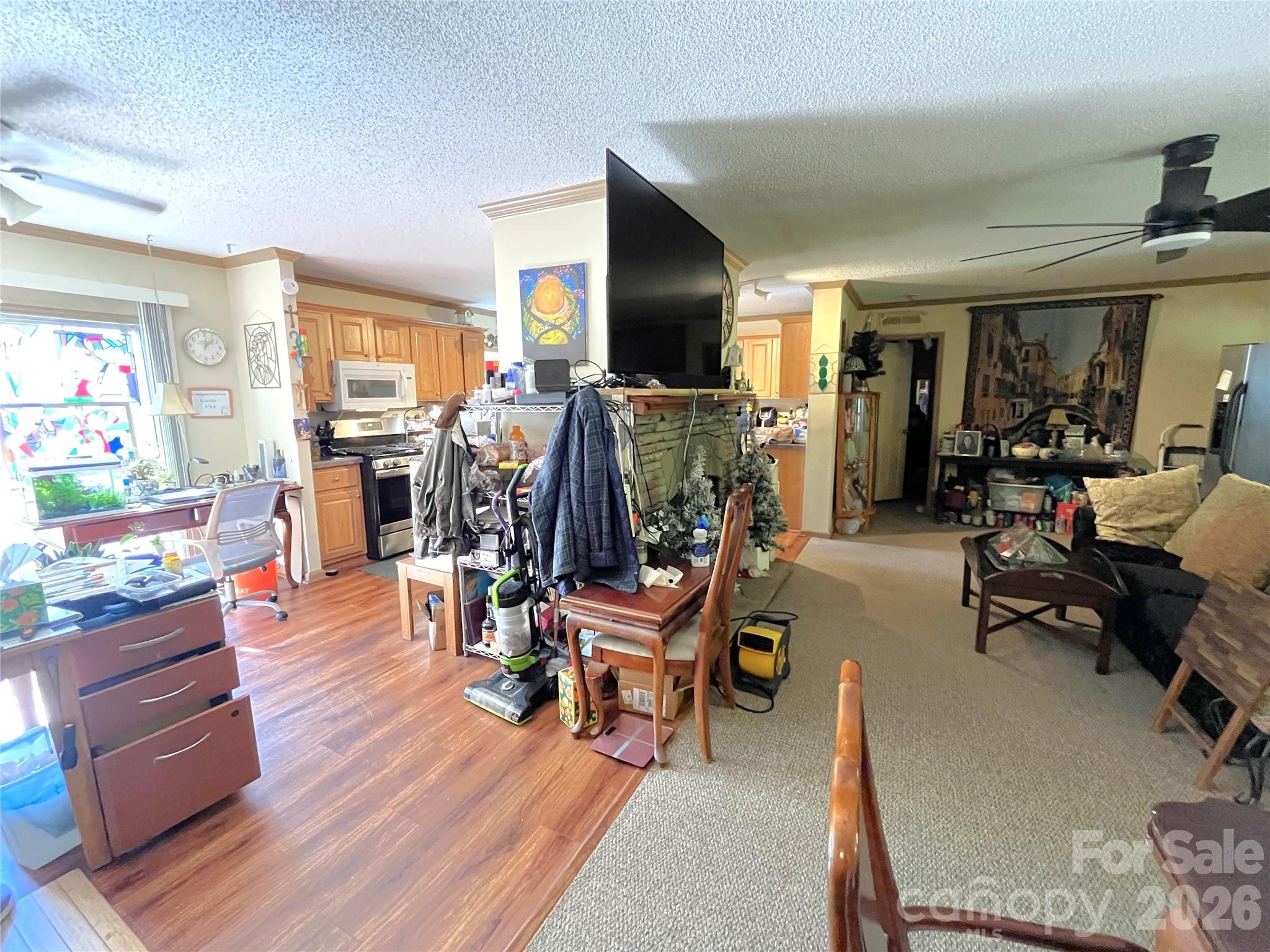 Fireplace dividing kitchen from living room - 121 Hidden Meadow Drive, Candler