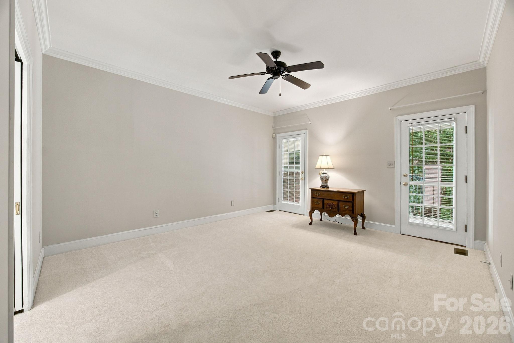 Primary Bedroom with doors leading out to the screened porch - 10417 Newberry Park Lane, Charlotte