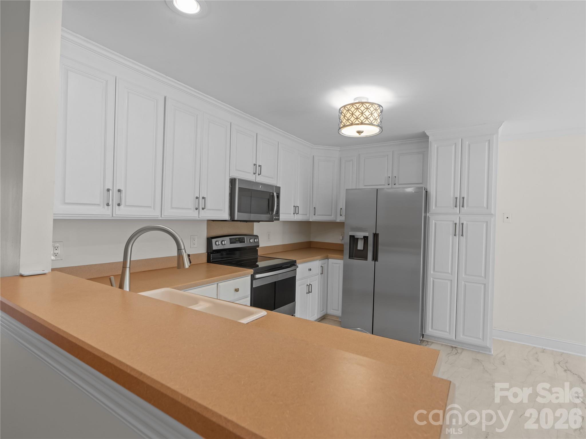 Pull up a bar stool and enjoy access to the kitchen and to the living room. - 1011 Overhill Road, Salisbury