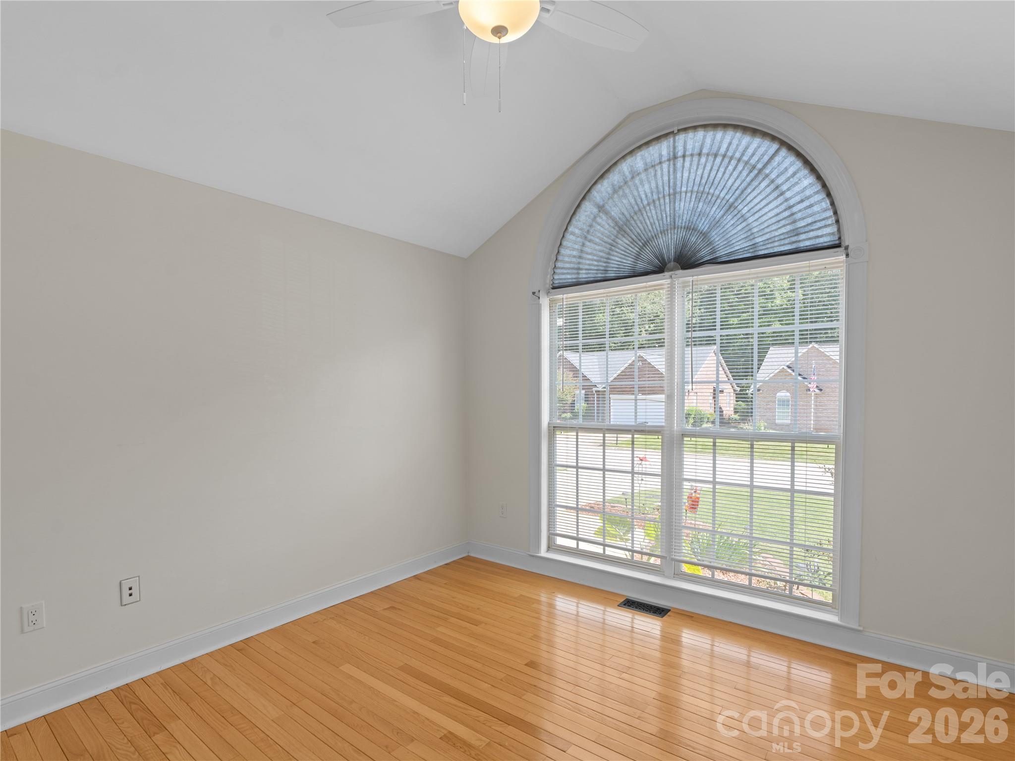 The secondary bedroom features beautiful hardwood floors, vaulted ceilis, newer light fixture/ceiling fan and large arched window that lets in tons of natural light. - 1011 Overhill Road, Salisbury