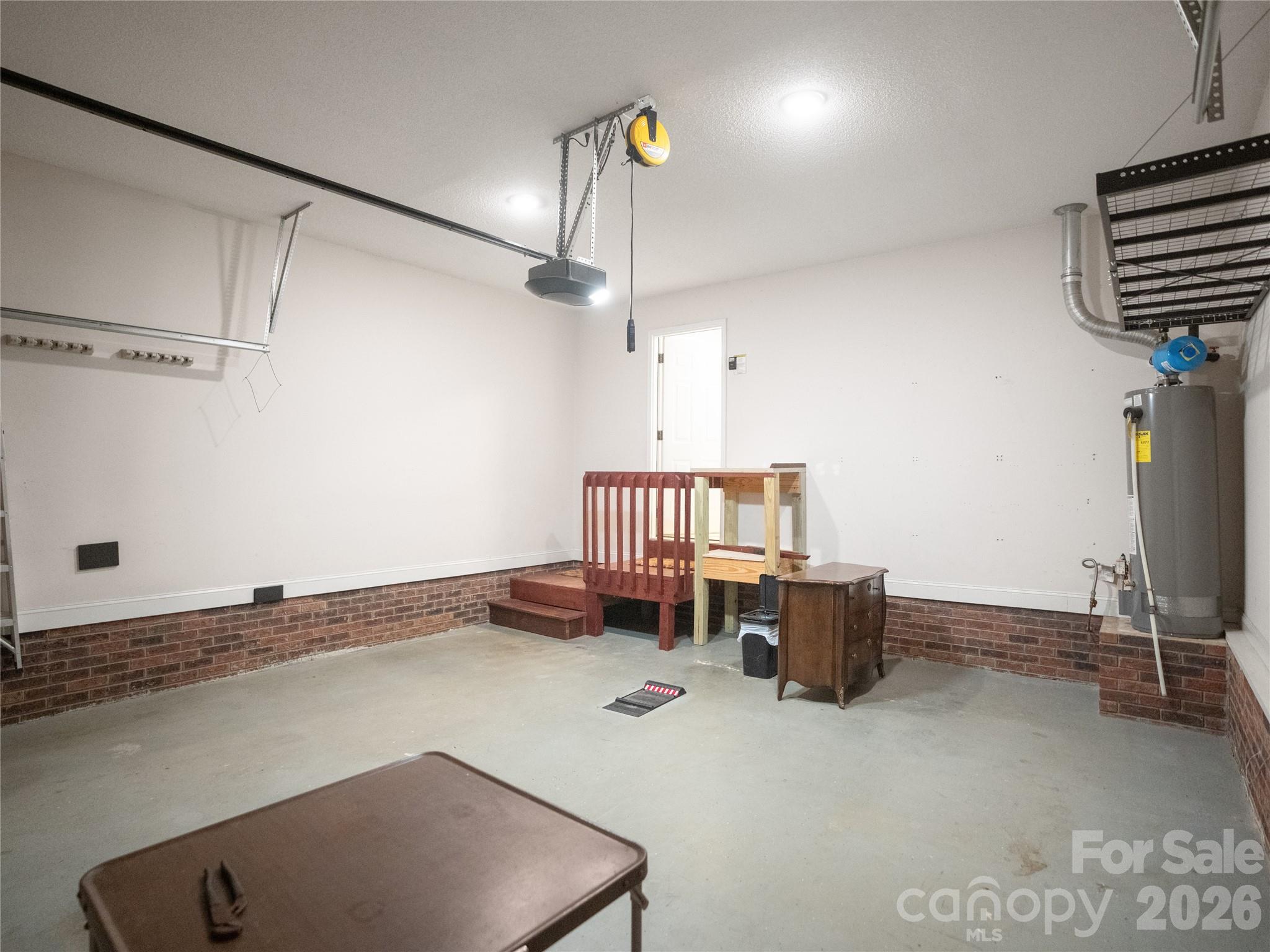 2 car garage with wifi compatible garage door opener and showcasing the entry to the house that lands you in the laundry room. - 1011 Overhill Road, Salisbury