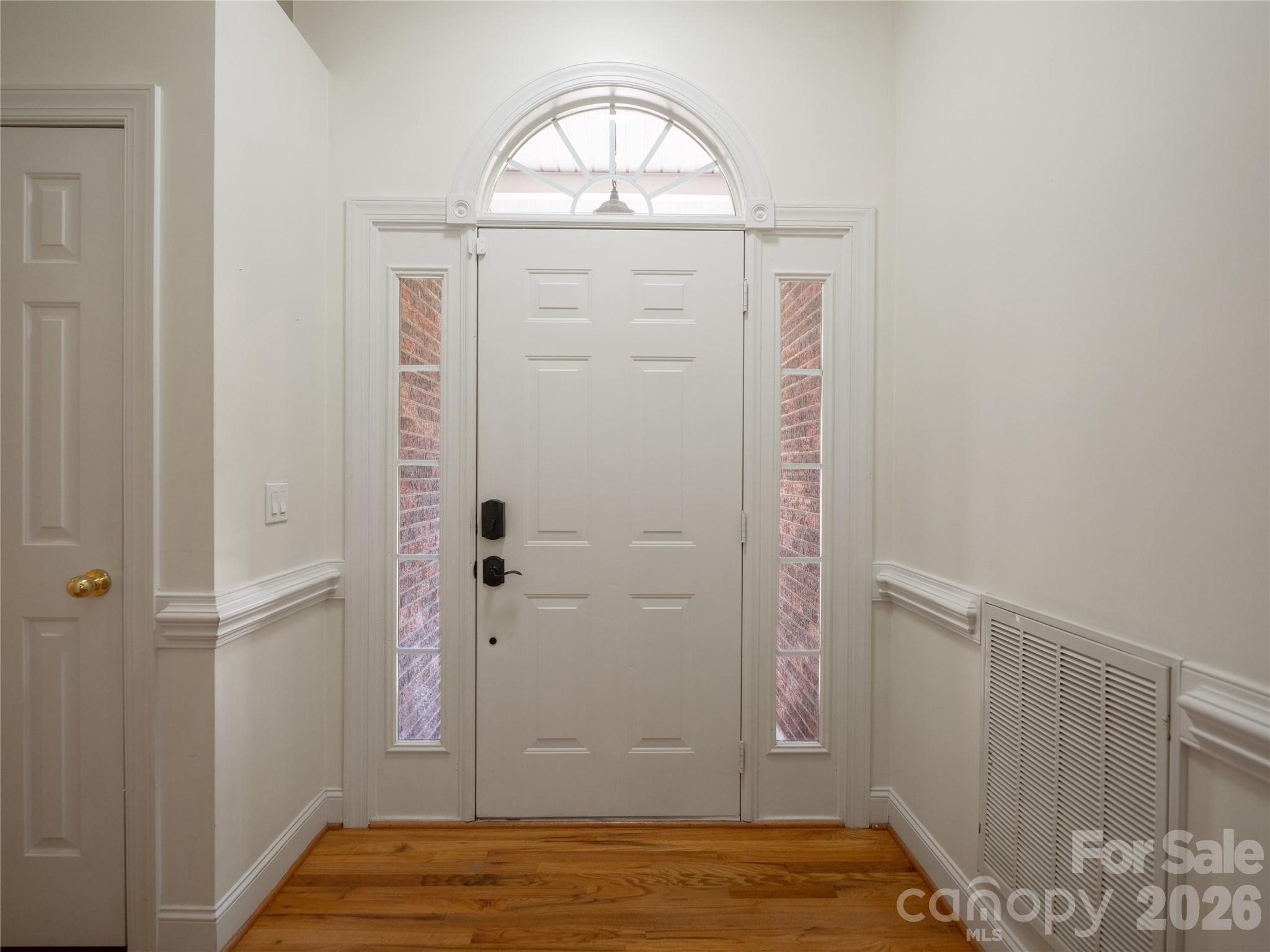 Front foyer features beautiful hardwood floors and new lighting. The front features a Pella screen door and the front door features thumb print remote locks and keyless entry keypad. - 1011 Overhill Road, Salisbury