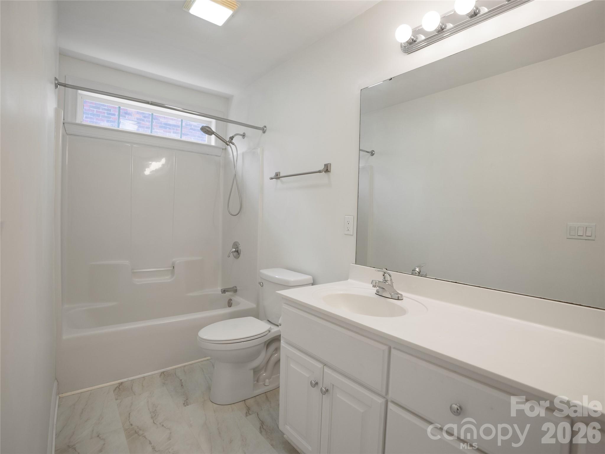Secondary bathroom showing off the double vanity, new LVP flooring and tub/shower with new shower faucet. - 1011 Overhill Road, Salisbury