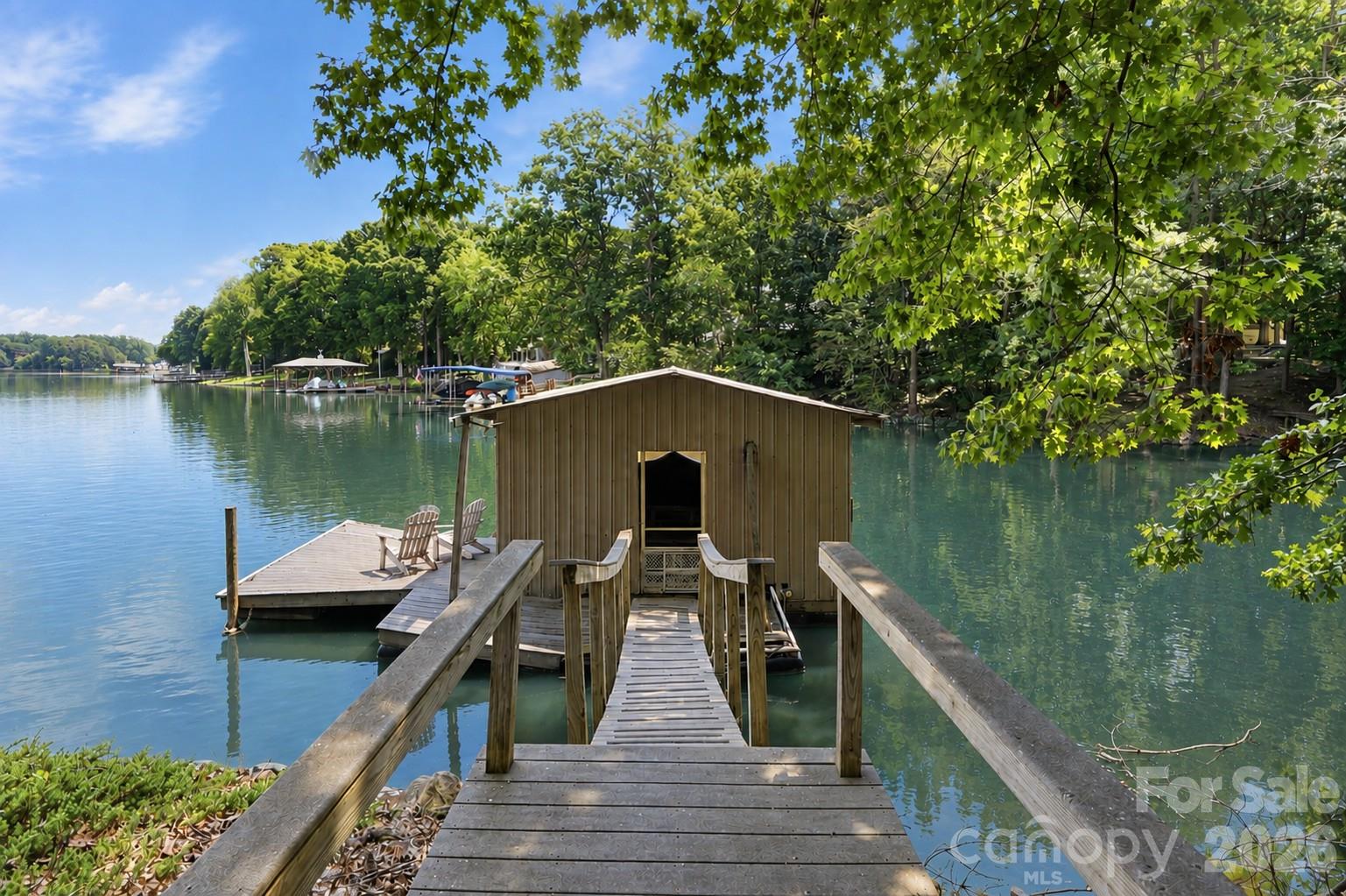 Private floating dock and boathouse offer immediate access for boating and water sports. - 1075 Lakefront Woods Drive, Belmont