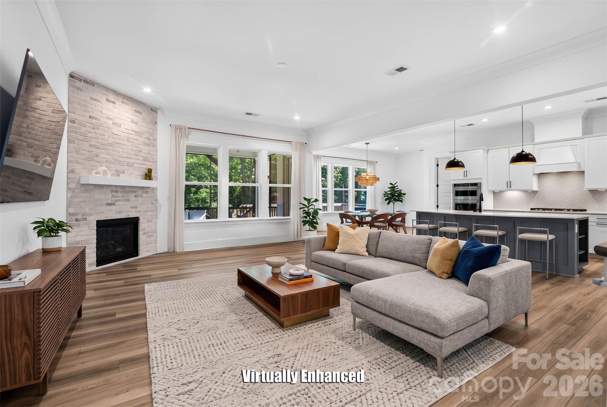 The heart of the home, a gas fireplace and space that invites you to exhale the moment you walk in. (Virtual Stage LR) - 1216 Glade Arch Lane, Huntersville