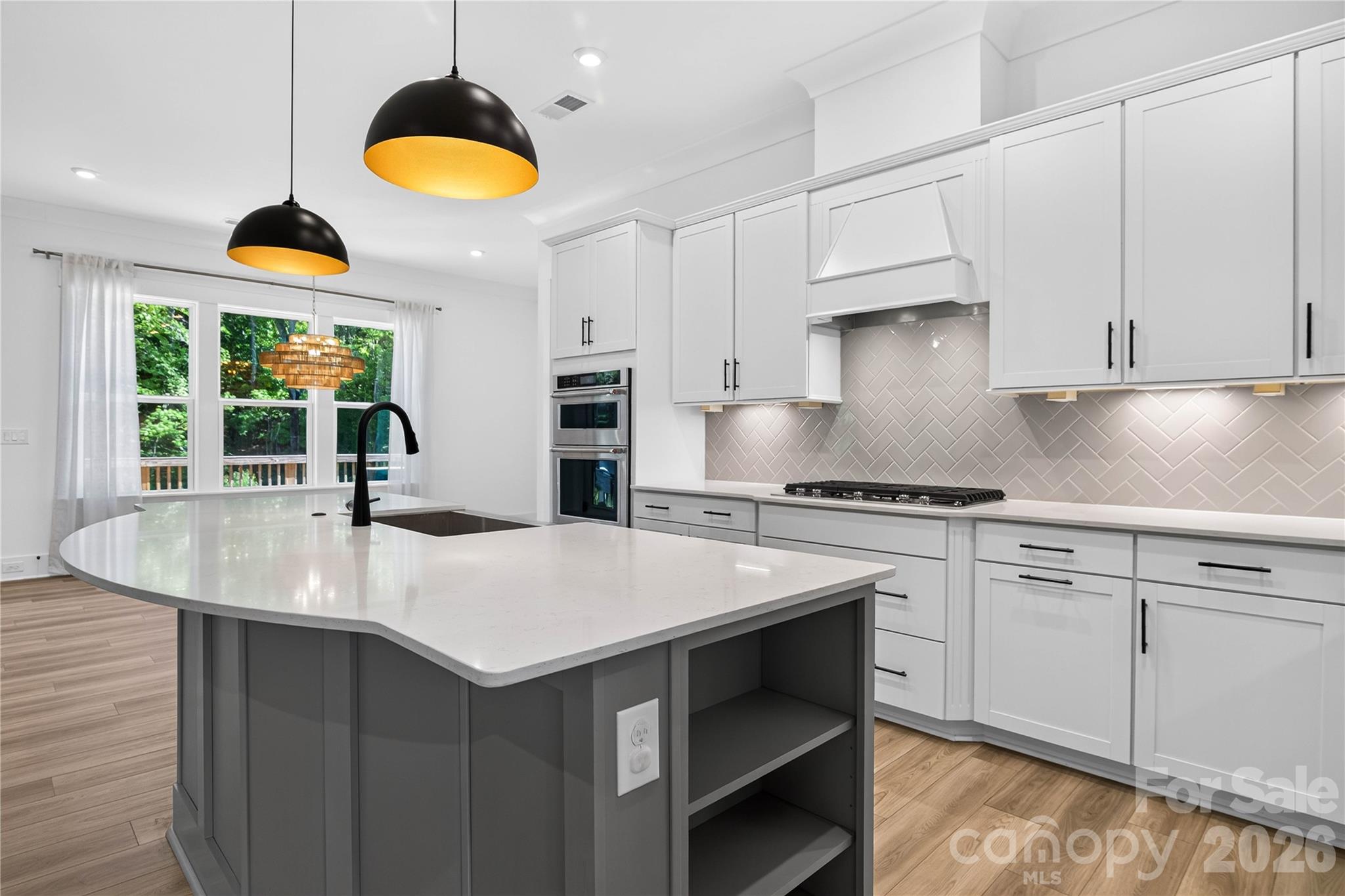 A chef's kitchen that means business. Gas cooktop, double wall ovens, walk in pantry. - 1216 Glade Arch Lane, Huntersville
