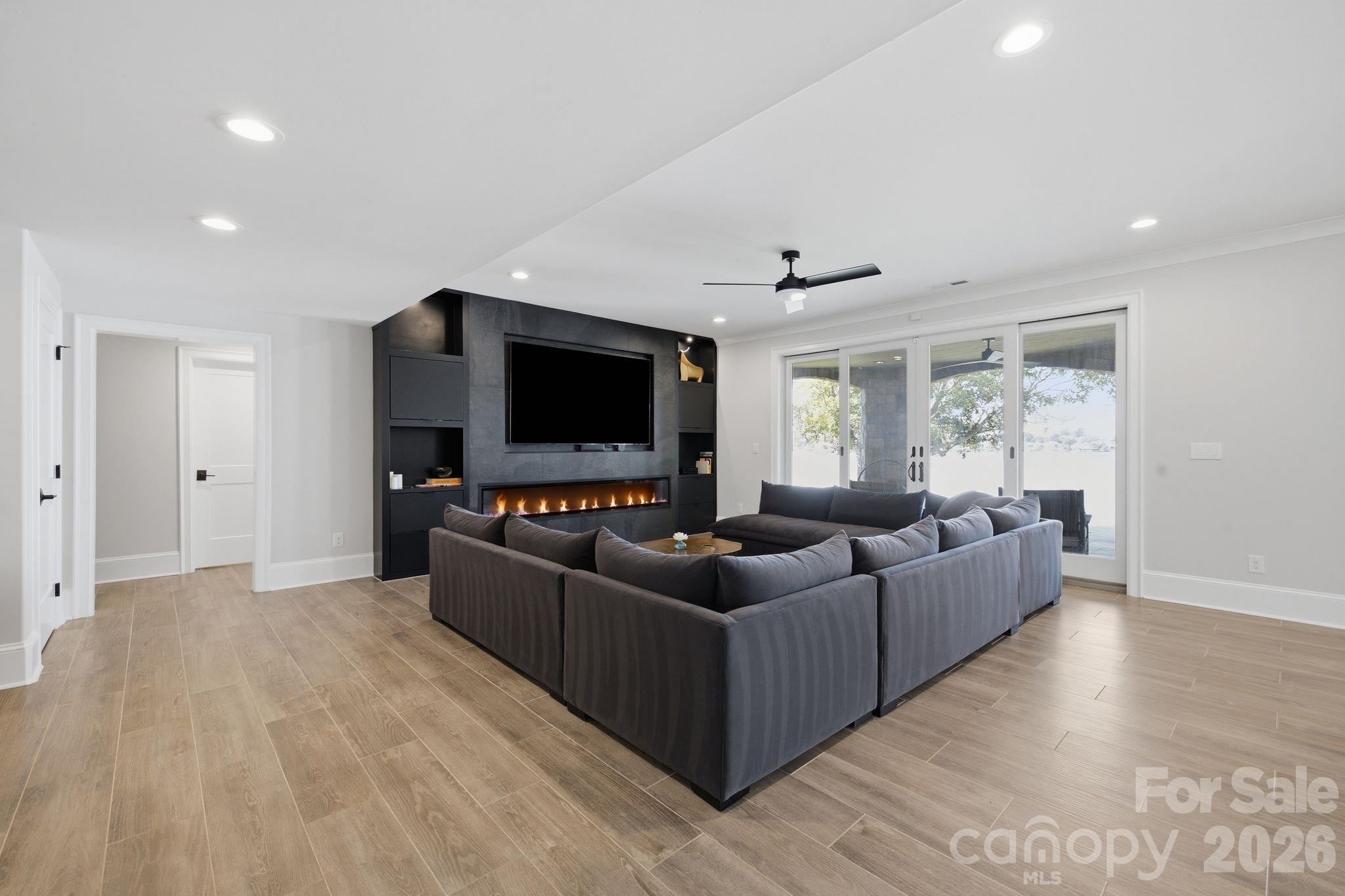 Pool level living room & entertainment space. - 112 Birdsong Lane, Mooresville