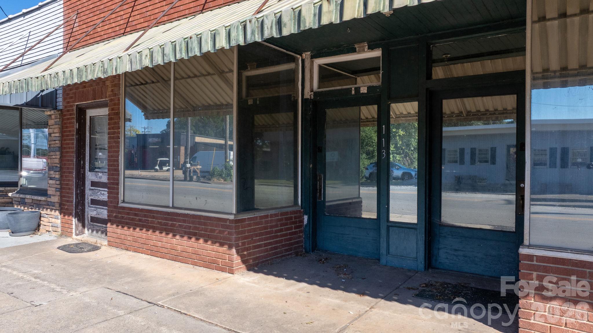 Two doors for two sperate retail spaces and single door for upstairs unit. - 113 E Main Street, Boonville