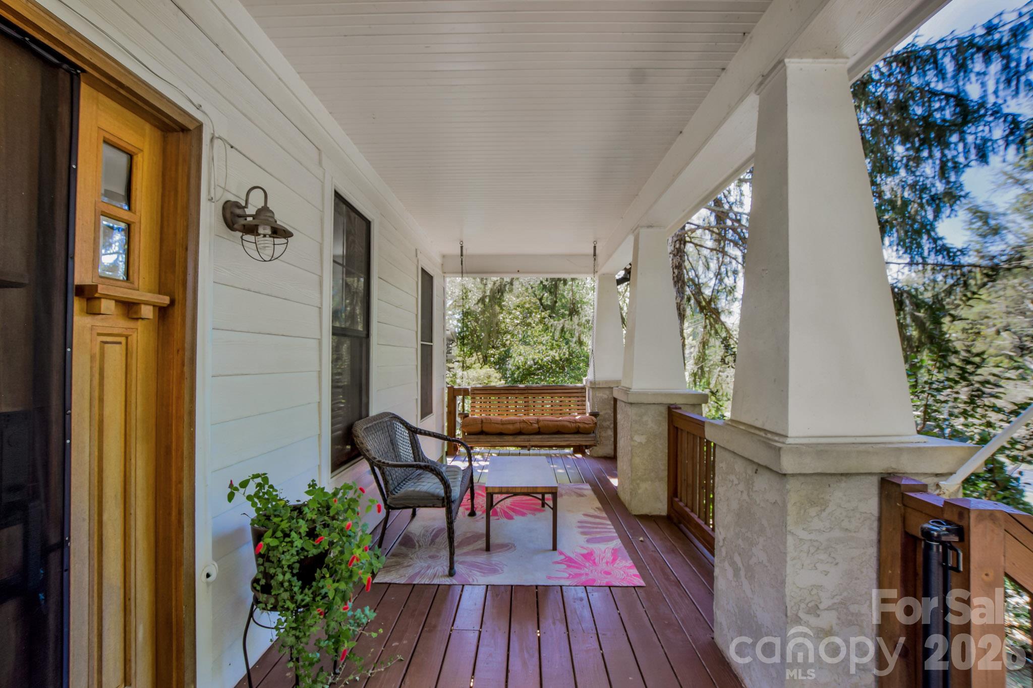 A sitting porch with a swing for enjoying the nature that surrounds you. - 92 Rumbough Place, Asheville