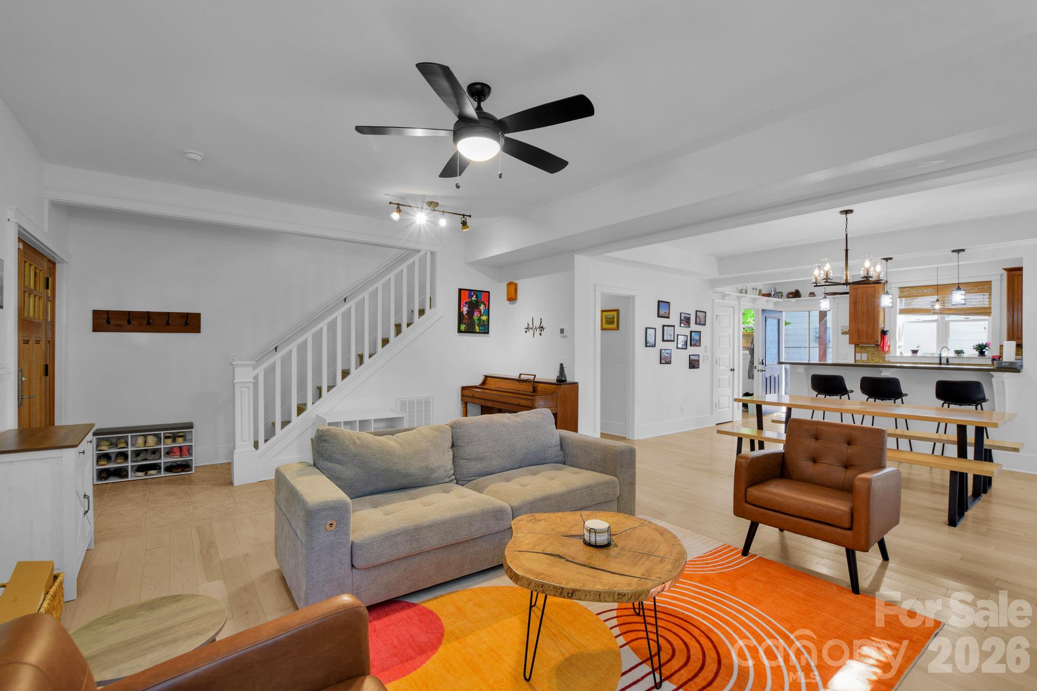 The main entrance to the home which is an open floor plan from the living room to the dining space and kitchen - 92 Rumbough Place, Asheville