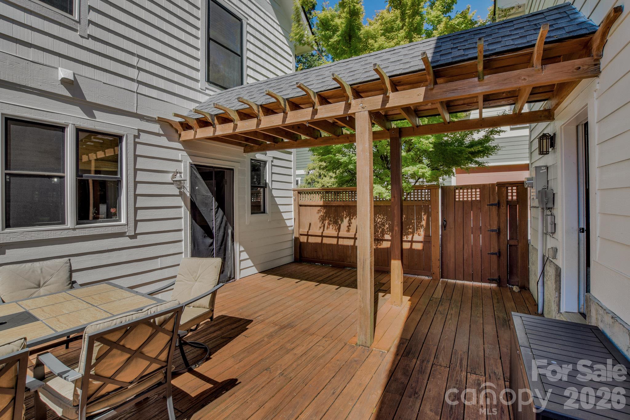 Patio connects to the 2-car garage and has a gate to the driveway - 92 Rumbough Place, Asheville