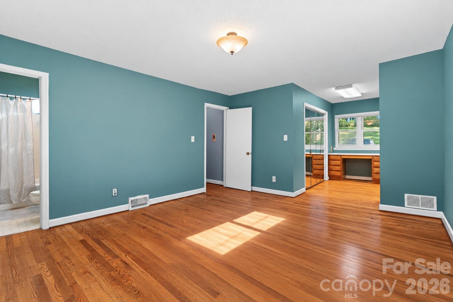 Primary bedroom with dressing vanity and ensuite bathroom - 18 Northwood Road, Asheville