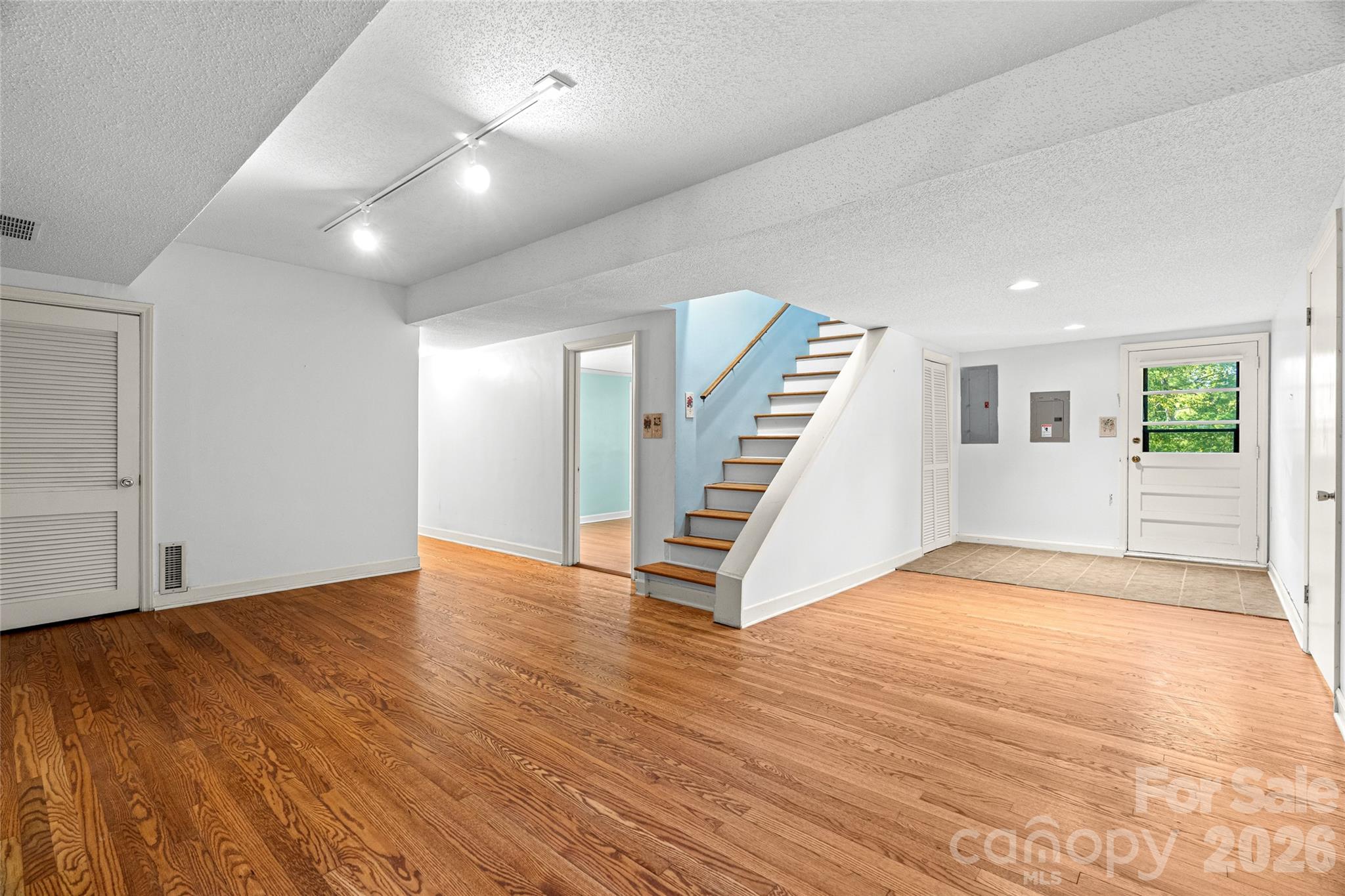 Spacious lower-level den provides a second living area with room to relax, entertain, or create a media space. - 18 Northwood Road, Asheville