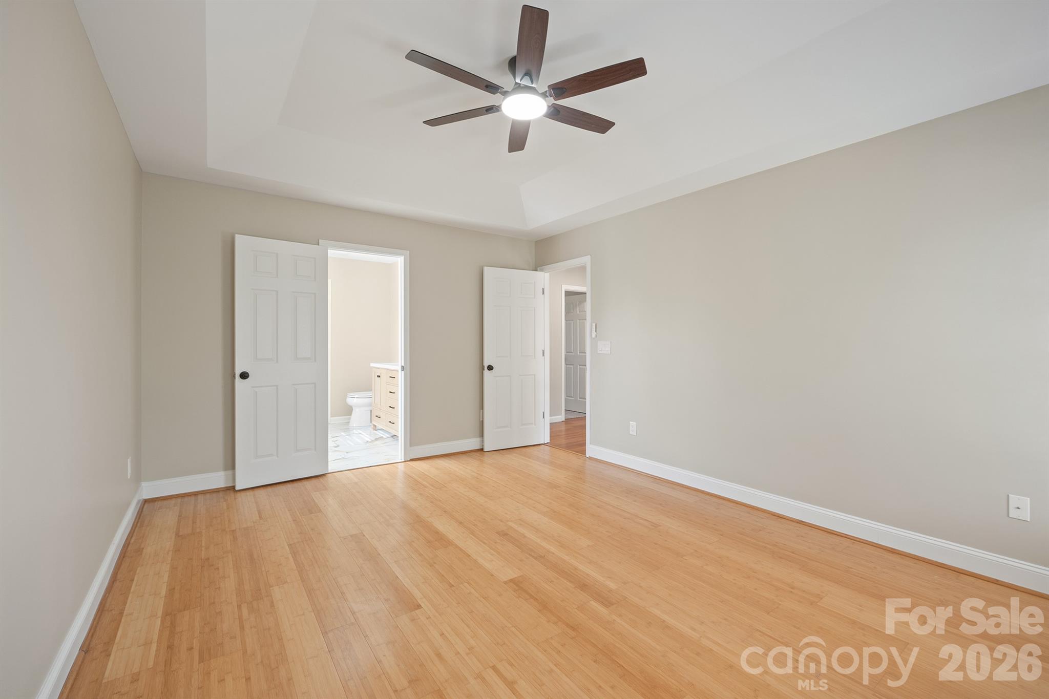 Primary bedroom with bamboo flooring and new paint - 110 Fox Den Circle, Statesville