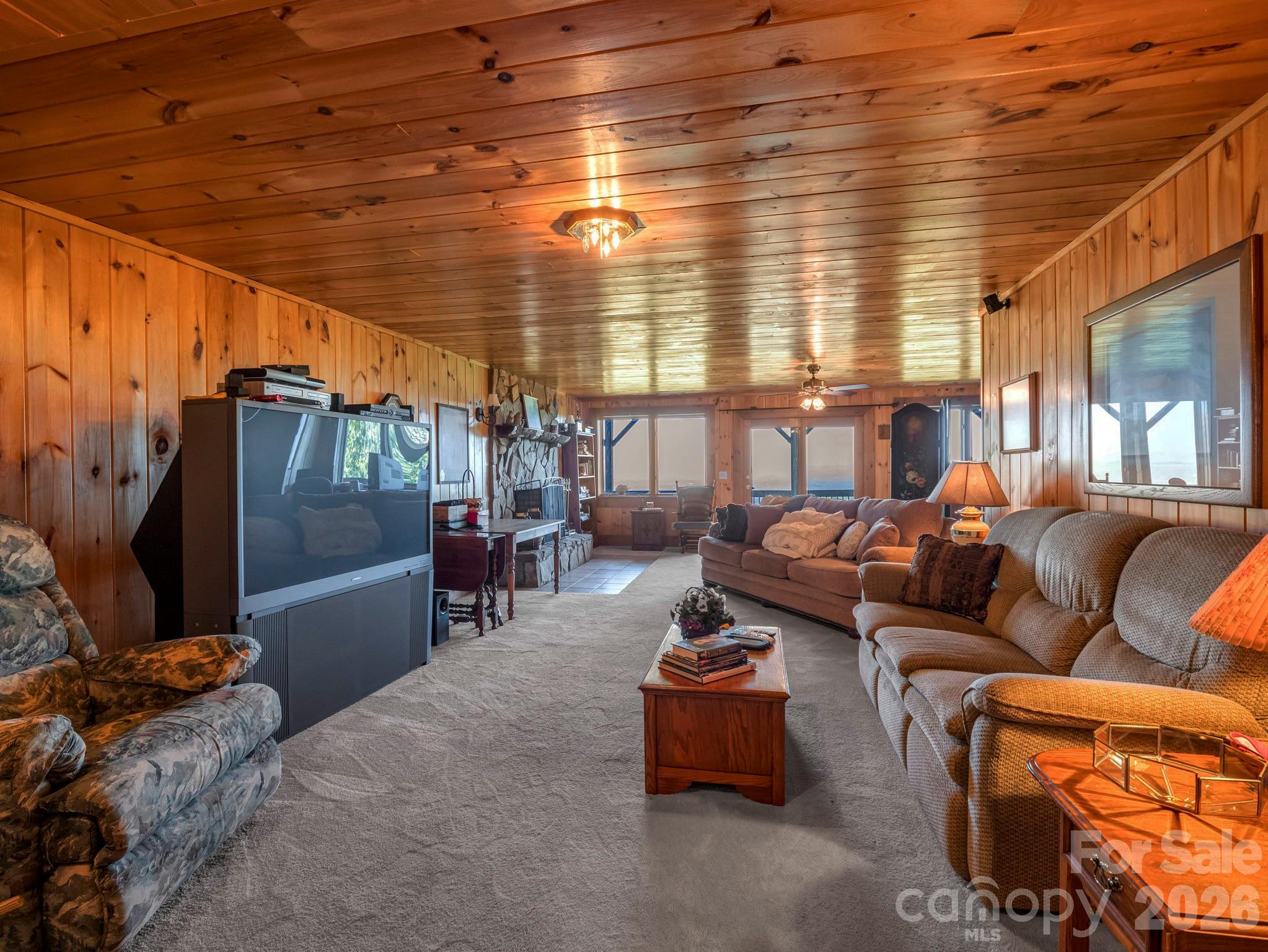 Lower family room with fireplace, study nook and sliding doors to lower deck - 5409 Mineral Springs Mountain Avenue, Valdese