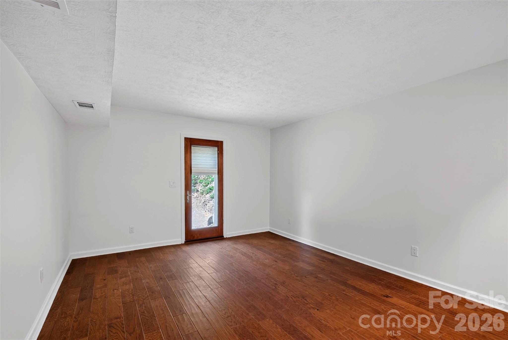 exterior entry to downstairs living area with natural light from Pella door - 53 Hemlock Street, Arden
