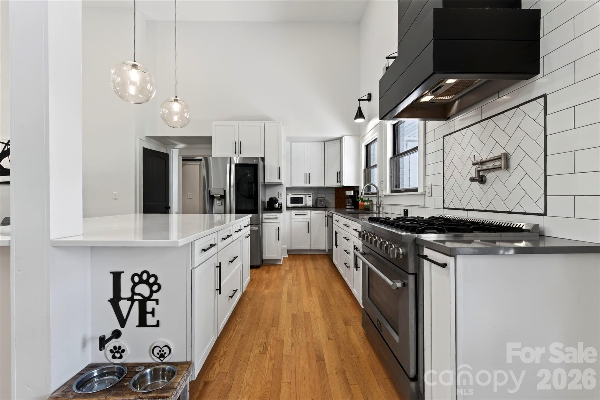 Stunning kitchen with oversized quartz island-done miss the water tap for pets! - 5 Inglewood Road, Asheville