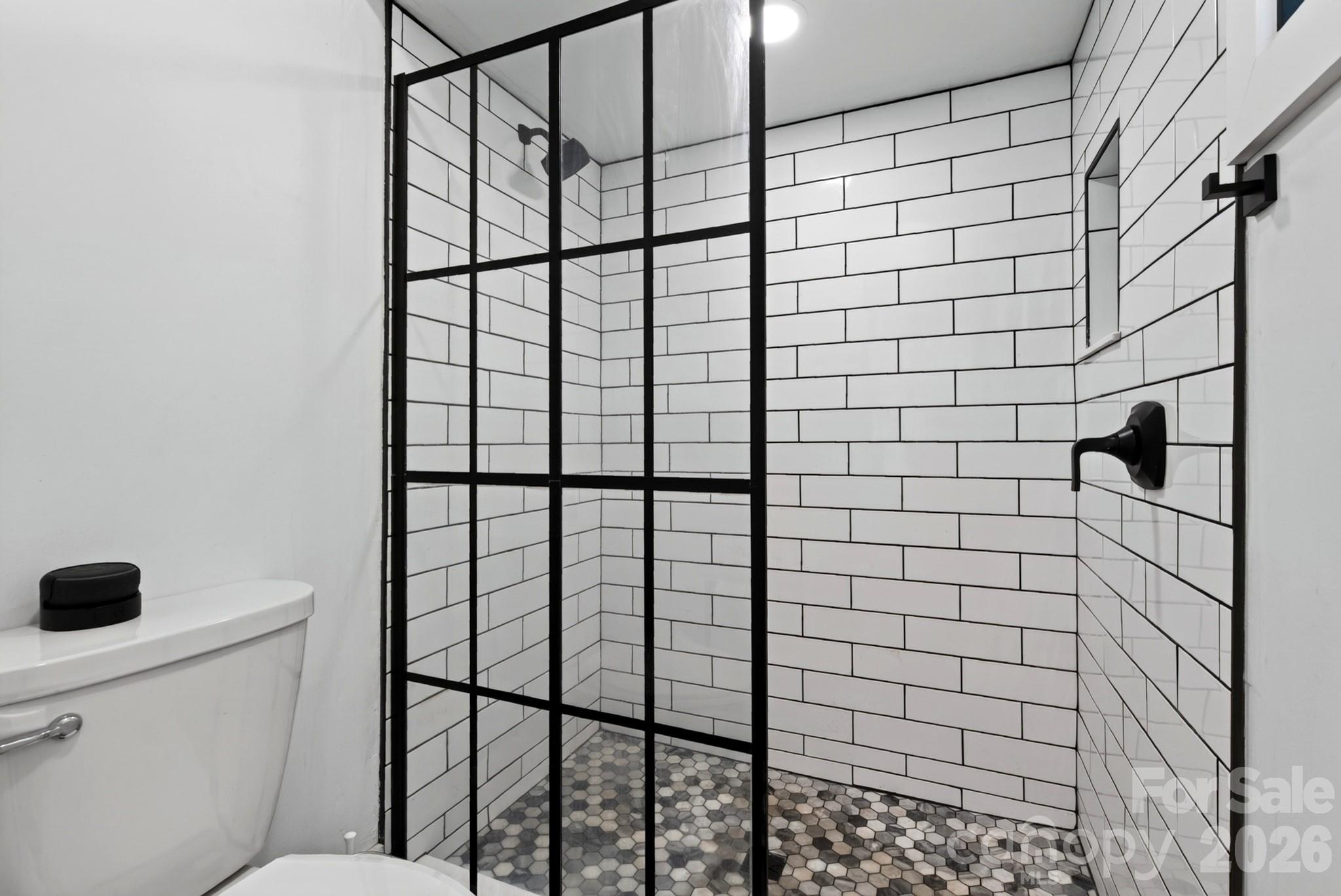 Attractive primary bathroom has floor to ceiling tile - 5 Inglewood Road, Asheville