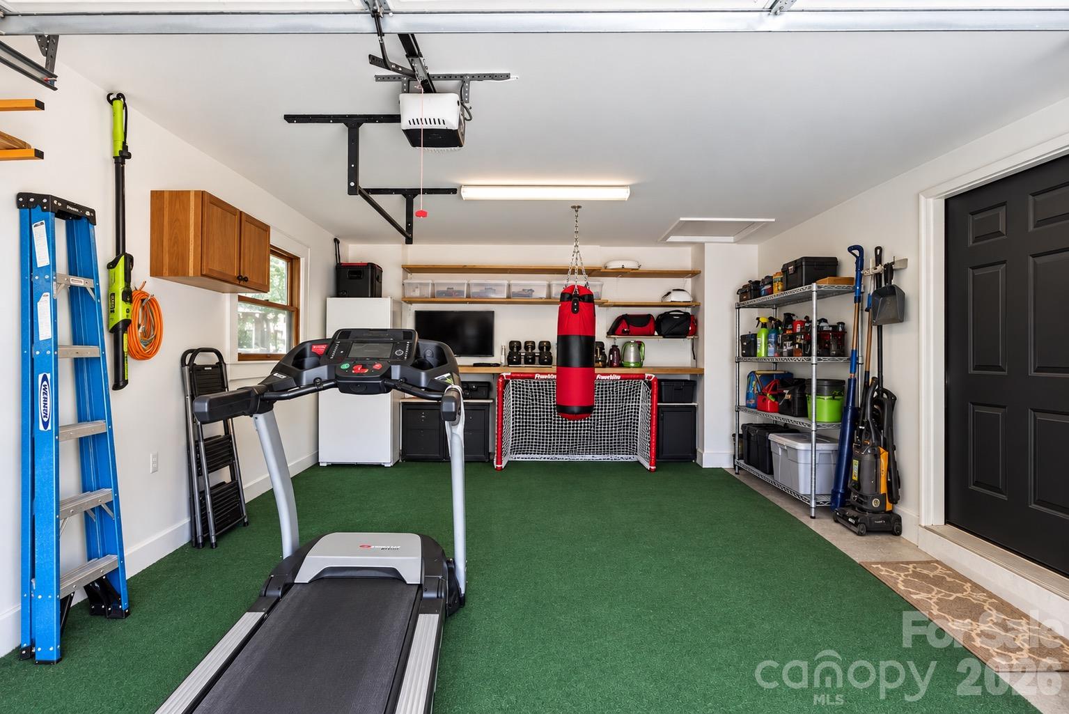 1 Car Garage used as a Gym. AI was used to clean this photo - 5 Inglewood Road, Asheville