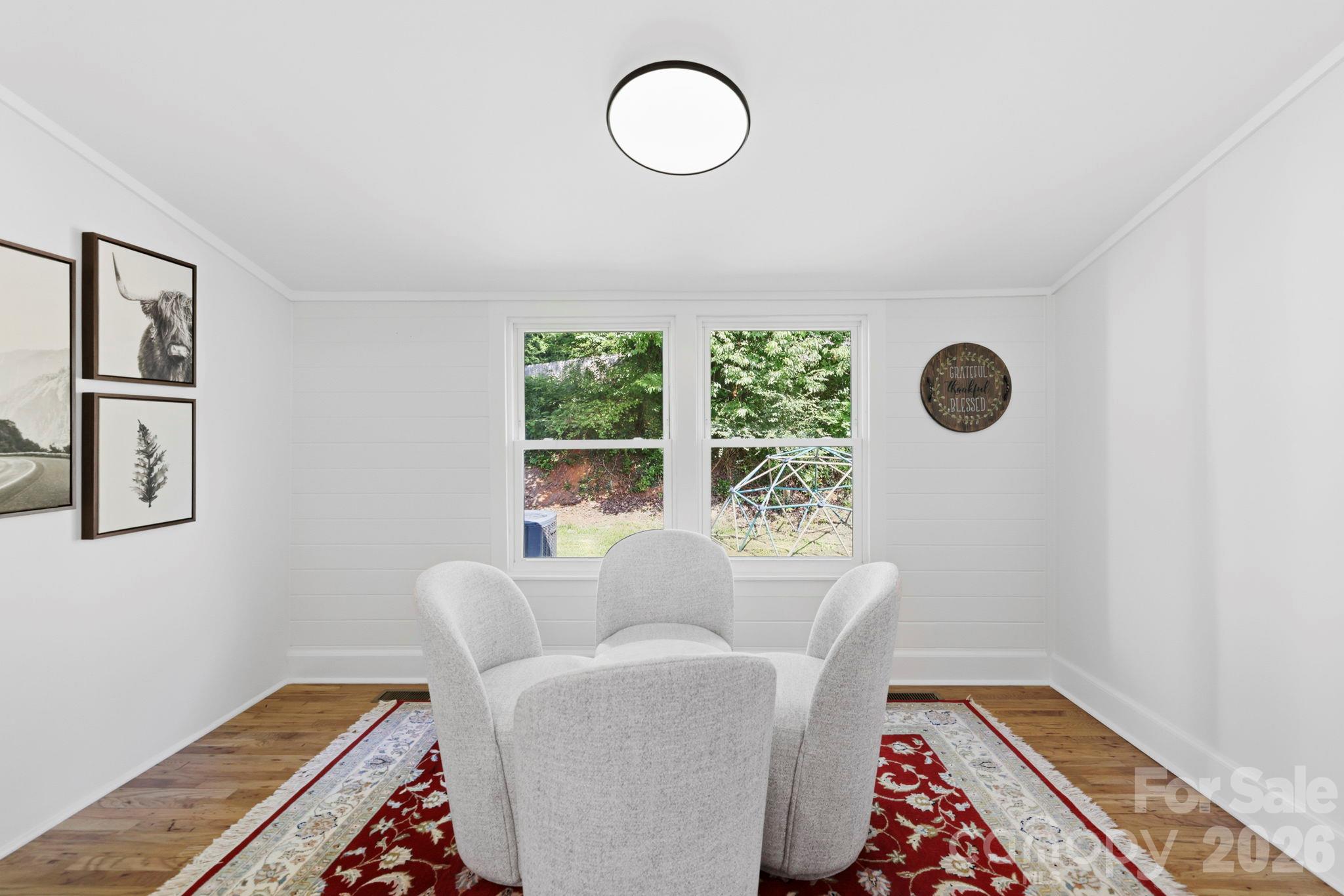 The sitting room adjacent to the dining room is a great place for morning coffee - 2252 Riceville Road, Asheville