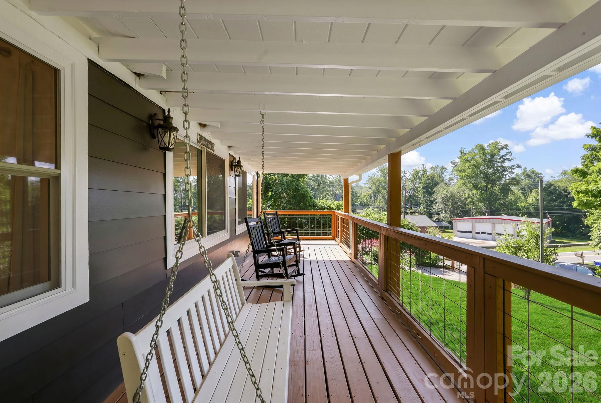 Classic covered porch complete with porch swing and rockers - 2252 Riceville Road, Asheville