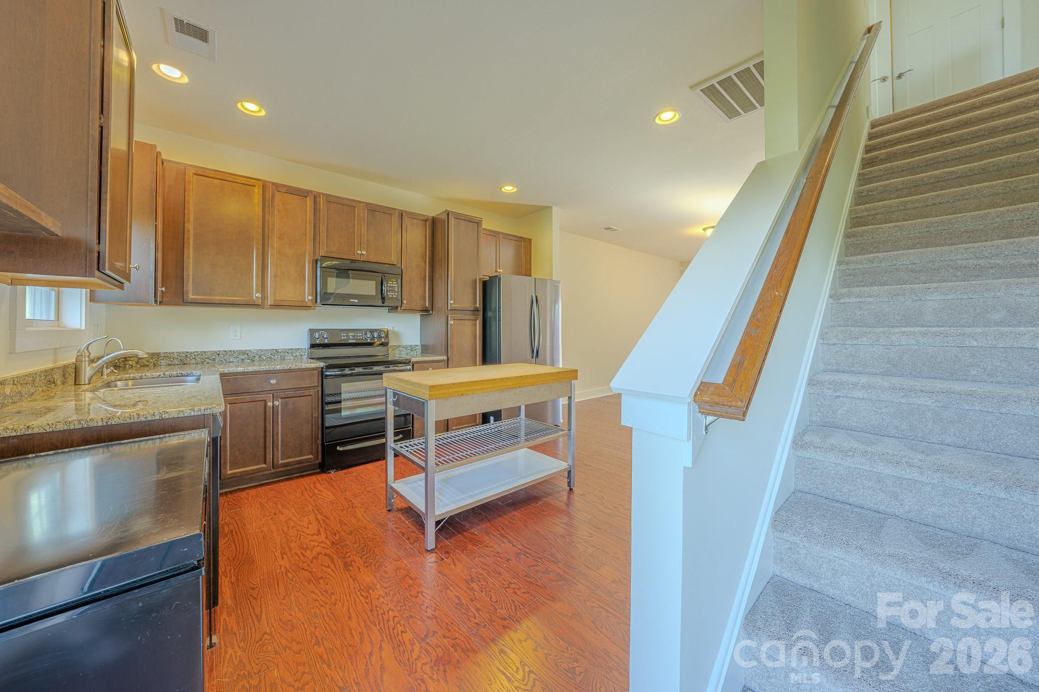 Kitchen with stairs leading to bedrooms - 623 Cardwell Lane, Fletcher