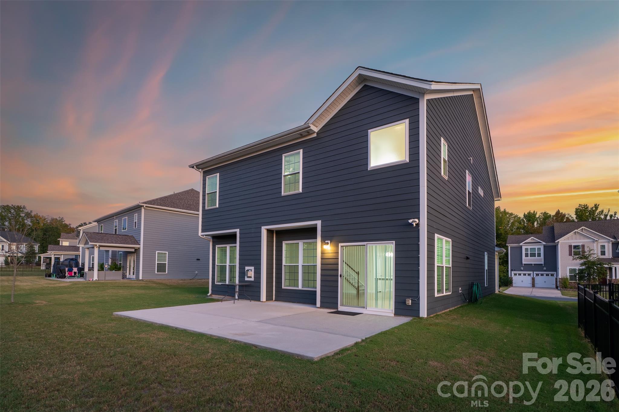View of home and extended patio from the rear yard. - 4638 Monument Valley Drive, Indian Land