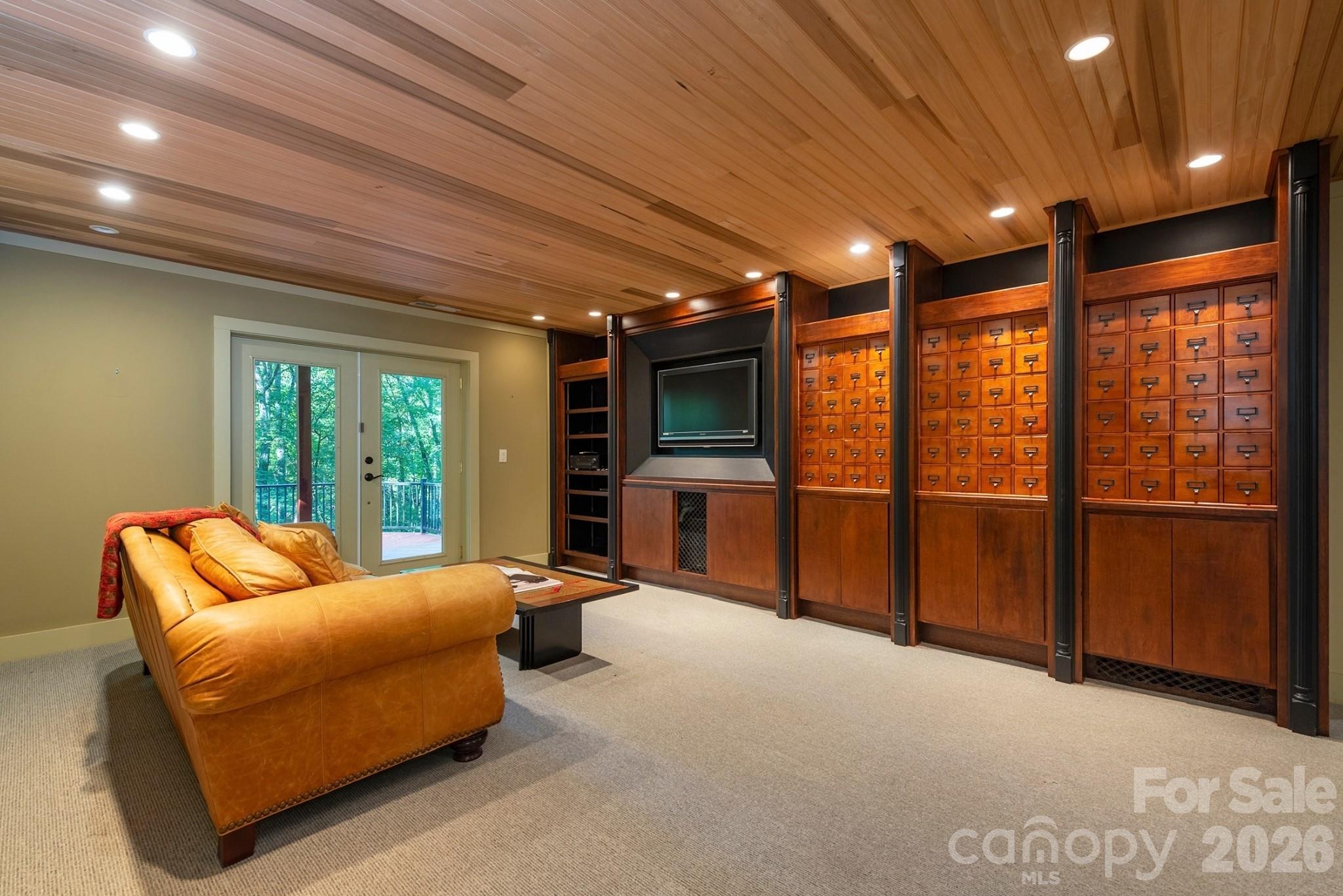Incredible family room entertainment space with endless storage! An absolute dream for crafters and gamers alike! - 190 Ridgeview Drive, Hendersonville