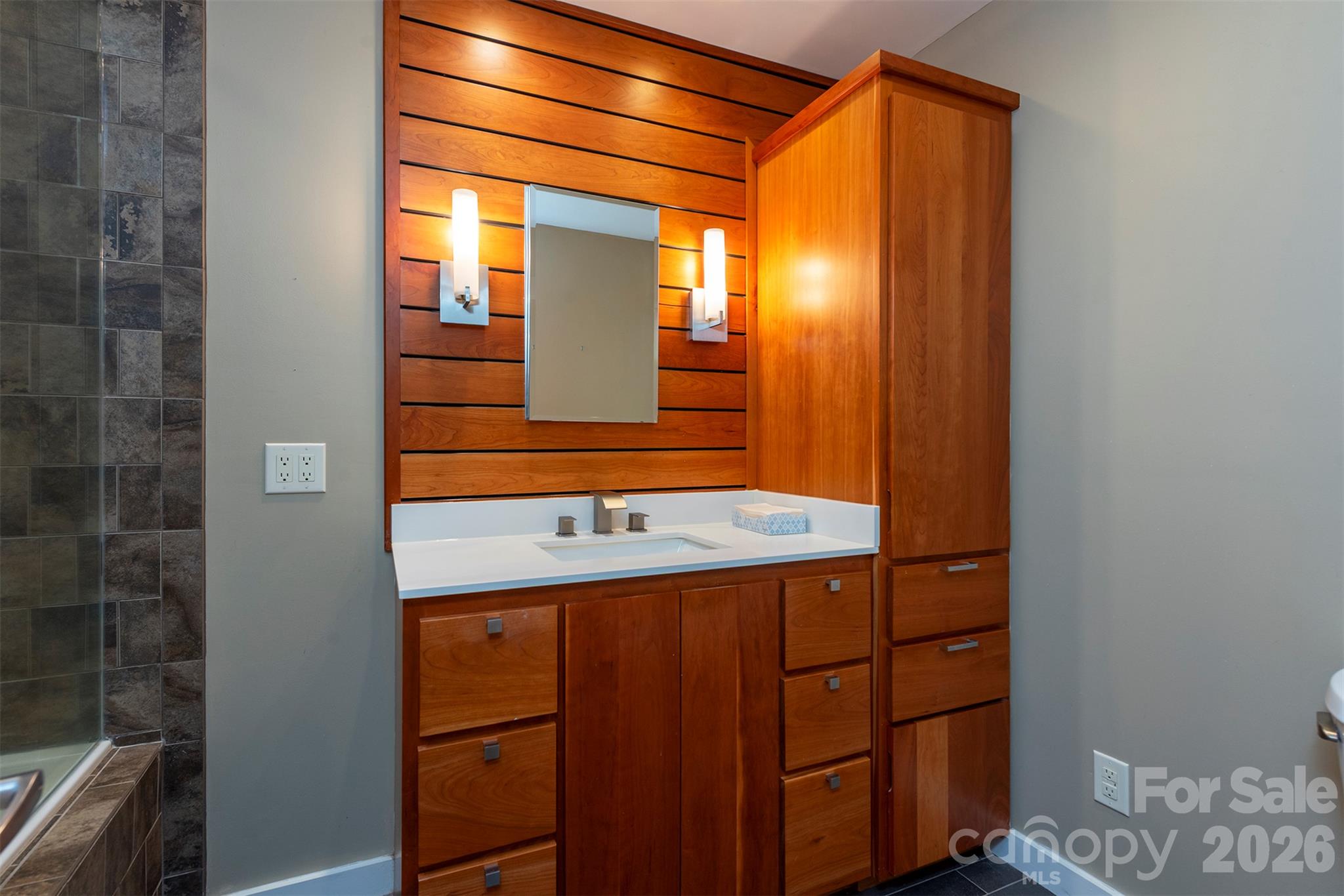 These bathrooms are gorgeous! Matching primary en suite and guest bathrooms upstairs have stylish wood accents. - 190 Ridgeview Drive, Hendersonville