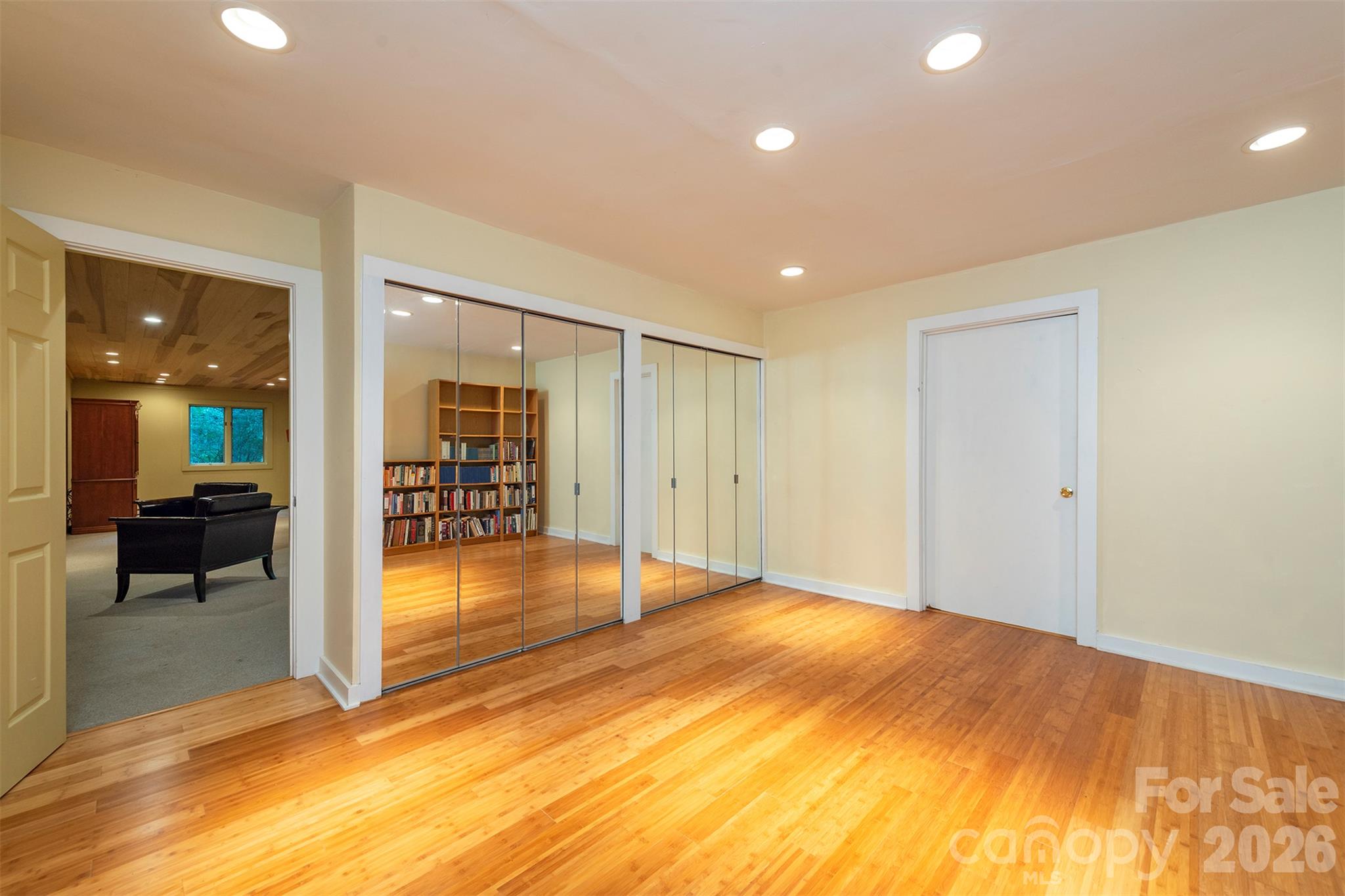 This unheated fitness area is great for workouts. The doorway takes you to the utility room and additional workshop space! - 190 Ridgeview Drive, Hendersonville