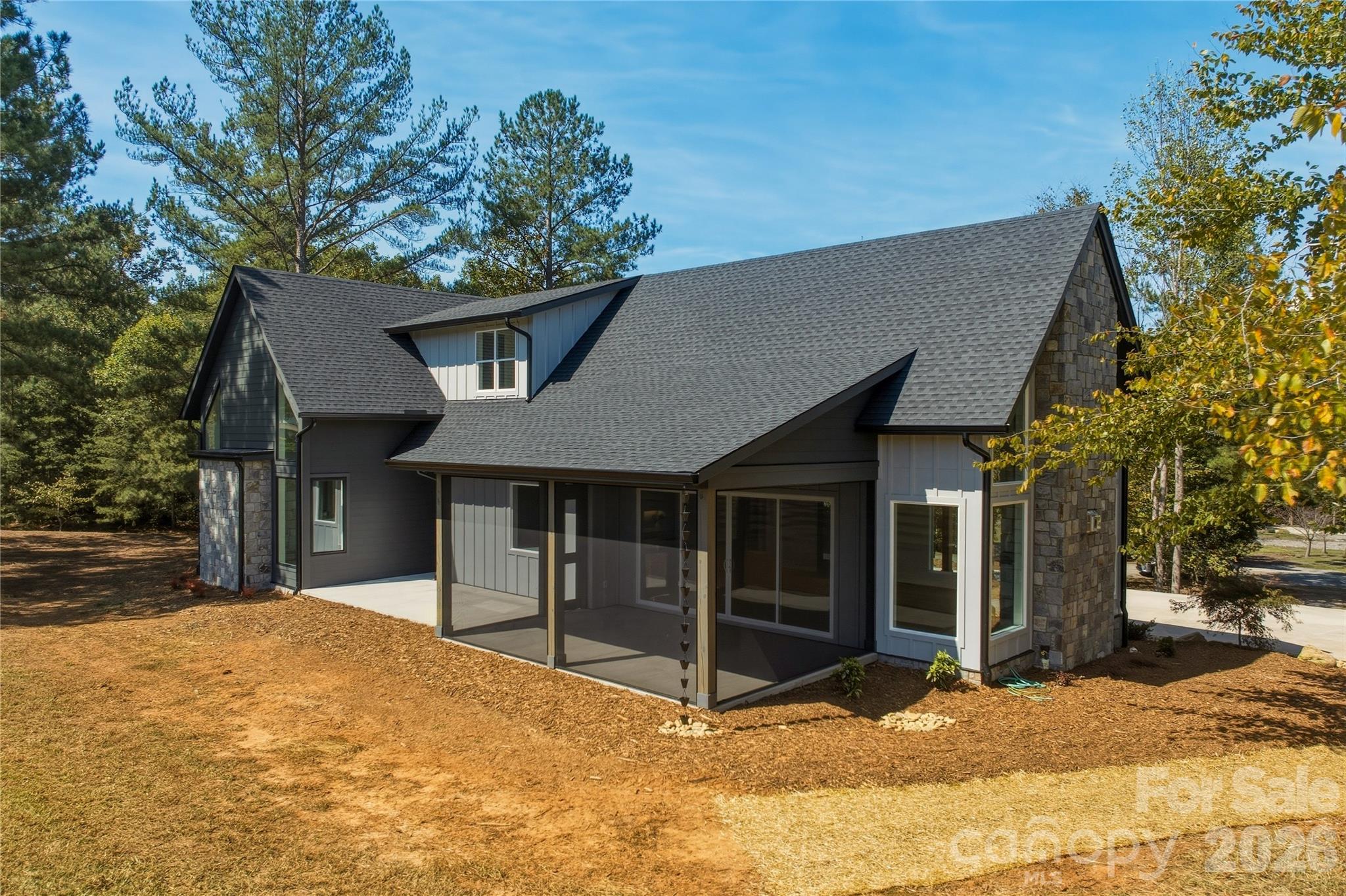 The back patio is screened and there are charming rain chains instead of traditional gutter downspouts along the front and rear porches as well as by the garage. - 2303 Paddock Circle, Morganton