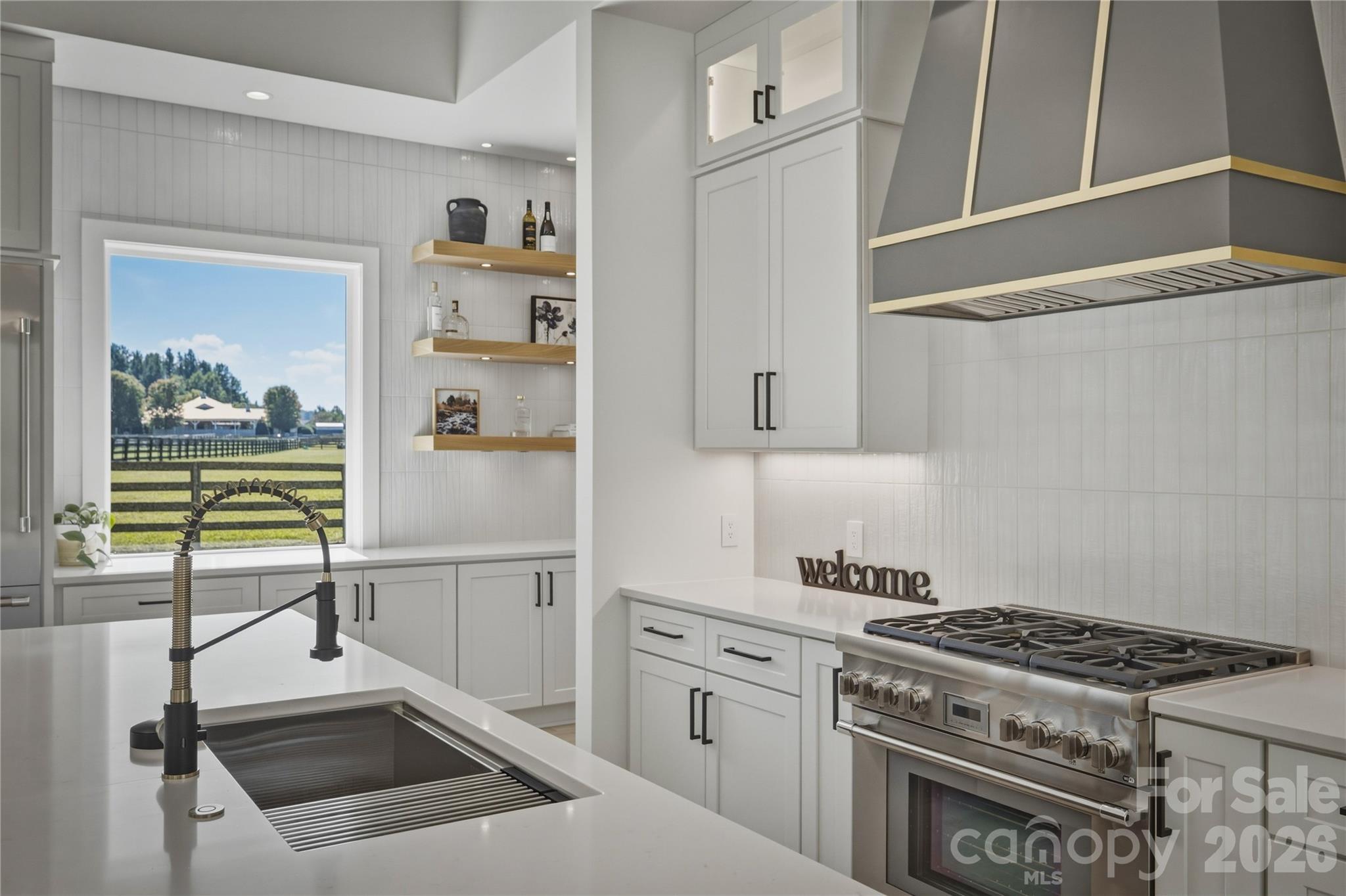 The gas range hood is exquisite. The Thermador appliance package will surely indulge the gourmet chefs of the family. - 2303 Paddock Circle, Morganton