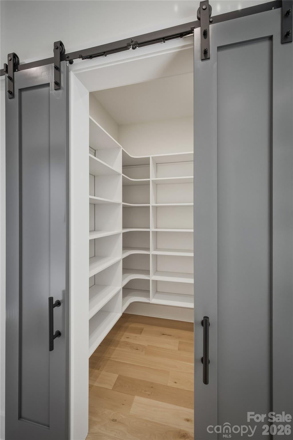 Behind these elegant barn doors, you will discover a walk-in pantry to keep all of your dry goods and kitchen supplies neatly stored away. - 2303 Paddock Circle, Morganton