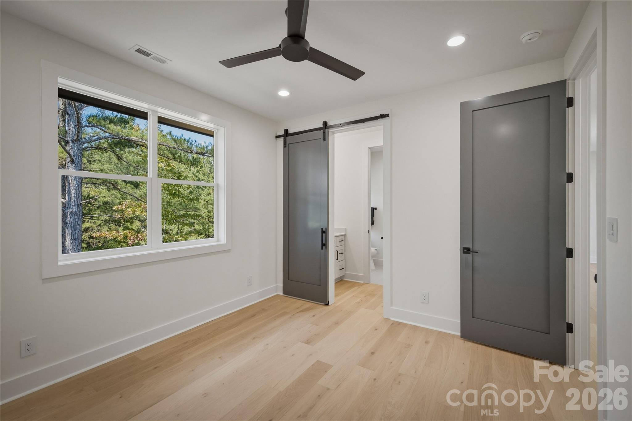 Through the barn door, you will find the Jack and Jill bathroom between this bedroom and Suite #3. - 2303 Paddock Circle, Morganton