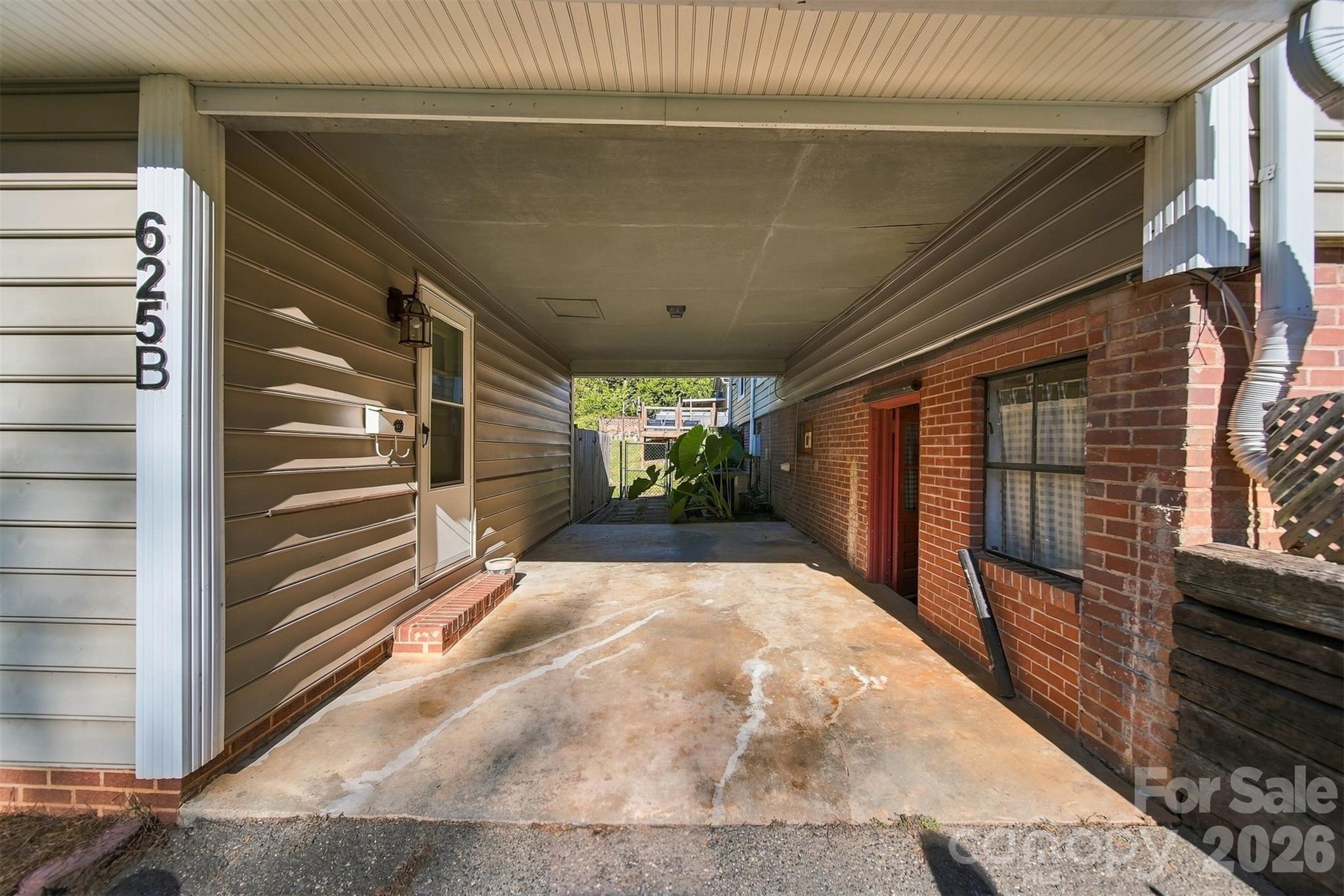 covered patio area between basement walkout and apartment. - 625 E Park Drive, Lincolnton