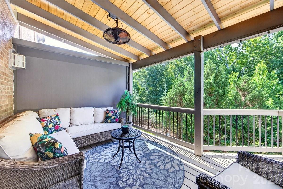 Upper deck covered with stair that have a landing leading to backyard patio with firepit - 3093 Hartson Pointe Drive, Fort Mill