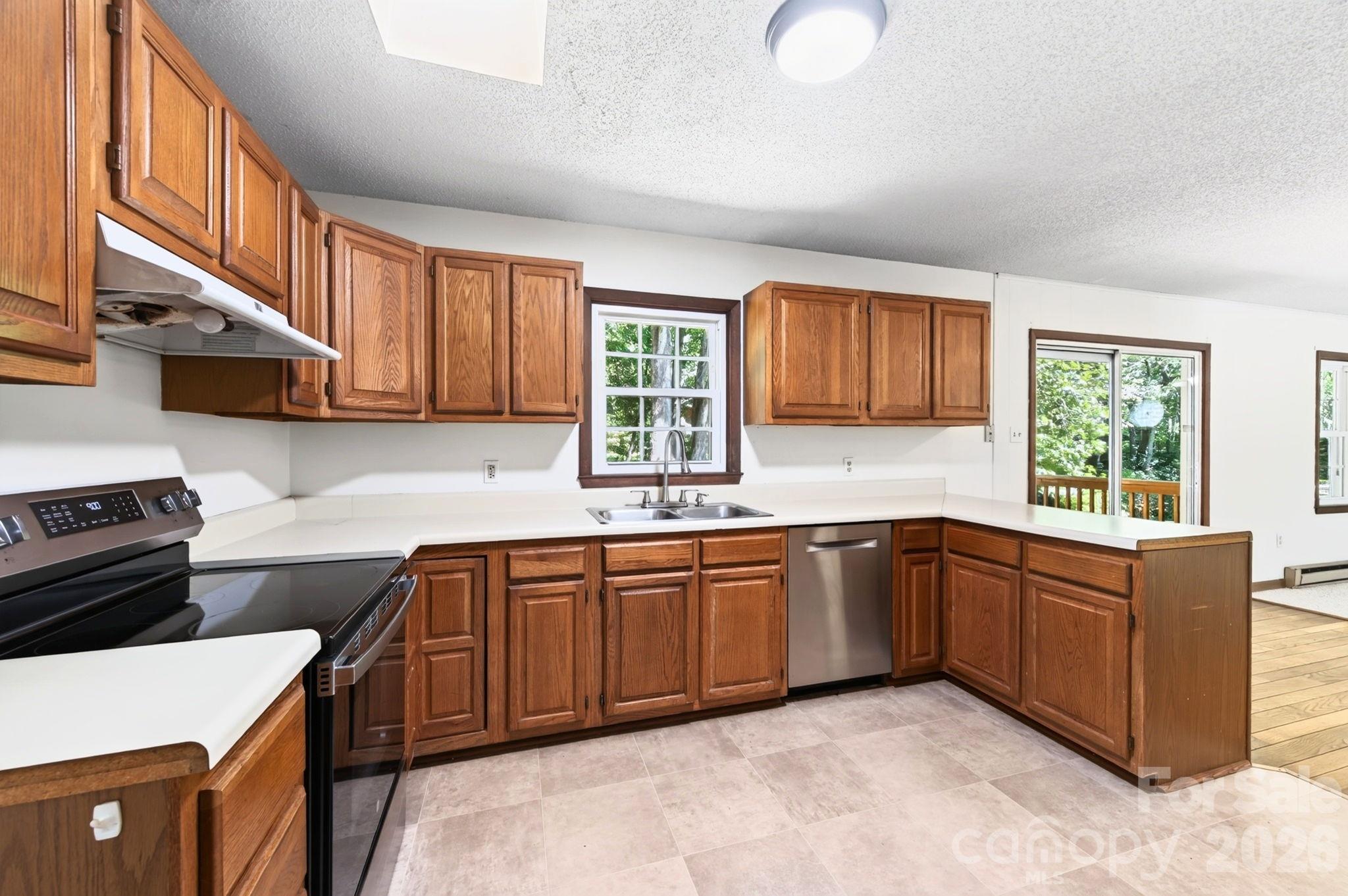 Kitchen with View of Back Yard - 340 Genesis Circle, Black Mountain