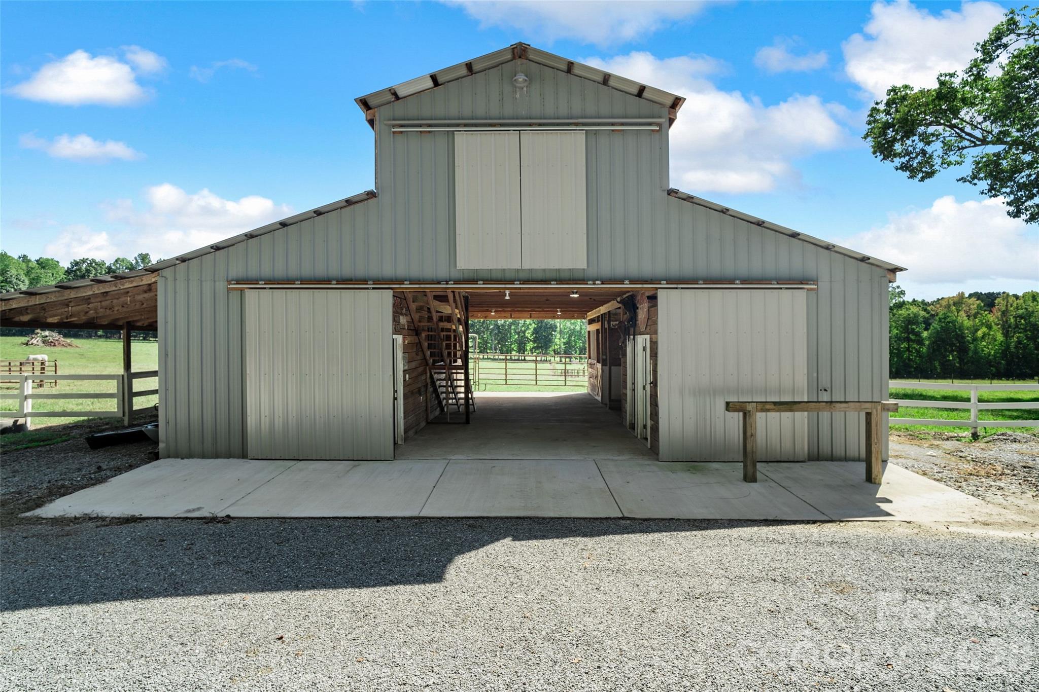 3 Stall Barn with tack room, hot/cold wash rack, 1/2 bath, feed room and hay loft. [41ft x 34ft] - 996 Beamguard Road, Clover