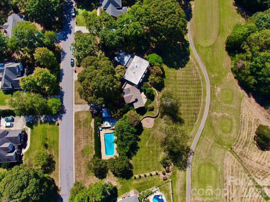 Aerial view showing the house, pool, large yard and view of golf course. - 4821 Elmhurst Drive NE, Hickory