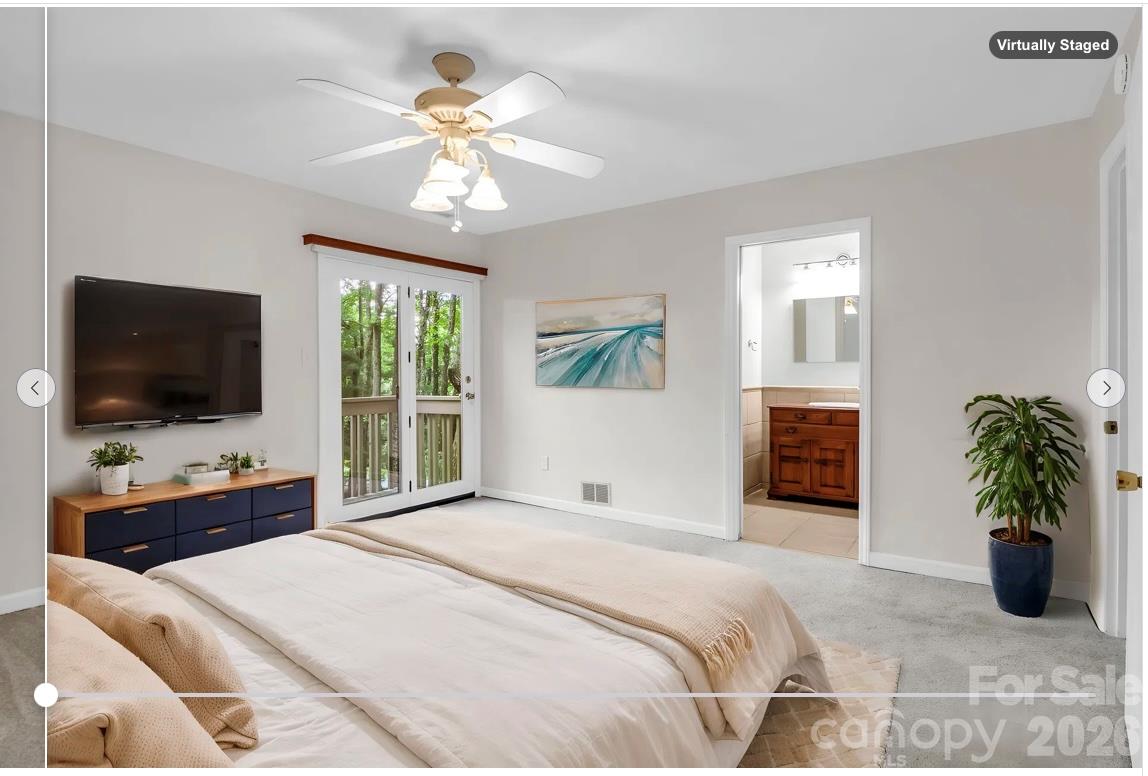 virtually staged: Primary Bedroom with private deck, en suite bathroom, large tile shower, walk-in closet - 10 Chestnut Ridge Road, Mills River